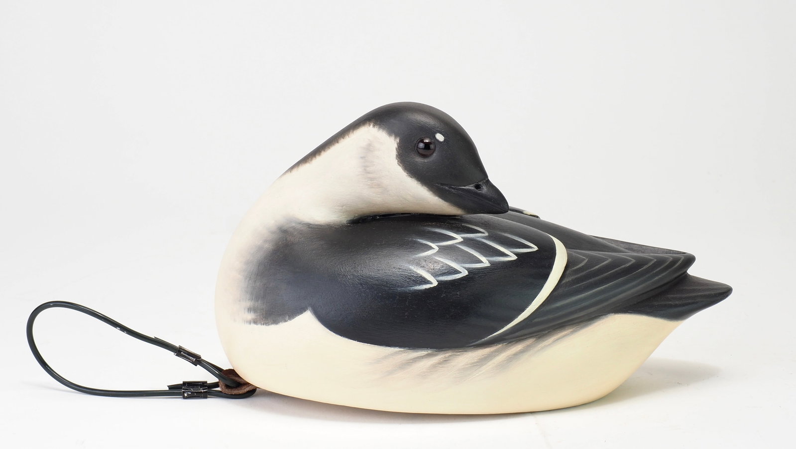 Keith Mueller - Preening Dovekie Personal Study Rig: Keith Mueller (b. 1956) Killingworth, CT 8.25" long In the carvers own notes on making dovekie and other Auk decoy species for wintering ground studies, "Since Dovekie and other Auk species winter