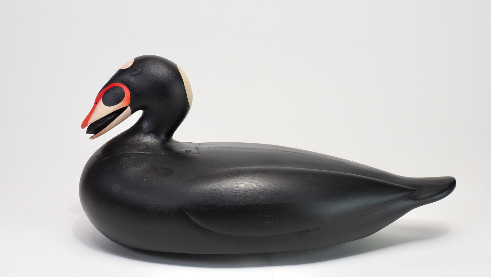 Keith Mueller - Surf Scoter Drake: Keith Mueller (b. 1956) Killingworth, CT 16.75" long Surf scoter with mussel in mouth. Inlet head design applied with cut nails, inspired by Portland Maine carver Gus Wilson. Raised relief carved