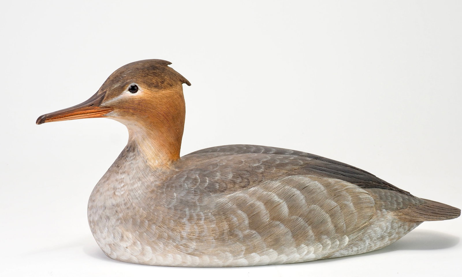 Kenneth Scheeler - Common Merganser Hen: Kenneth A. Scheeler (1928-2015) North Vineland, NJ, 1976 13.5" long Hollow carved with a slightly turned head and intricate carved feathering across the head and body. Glass eyes with carved bill