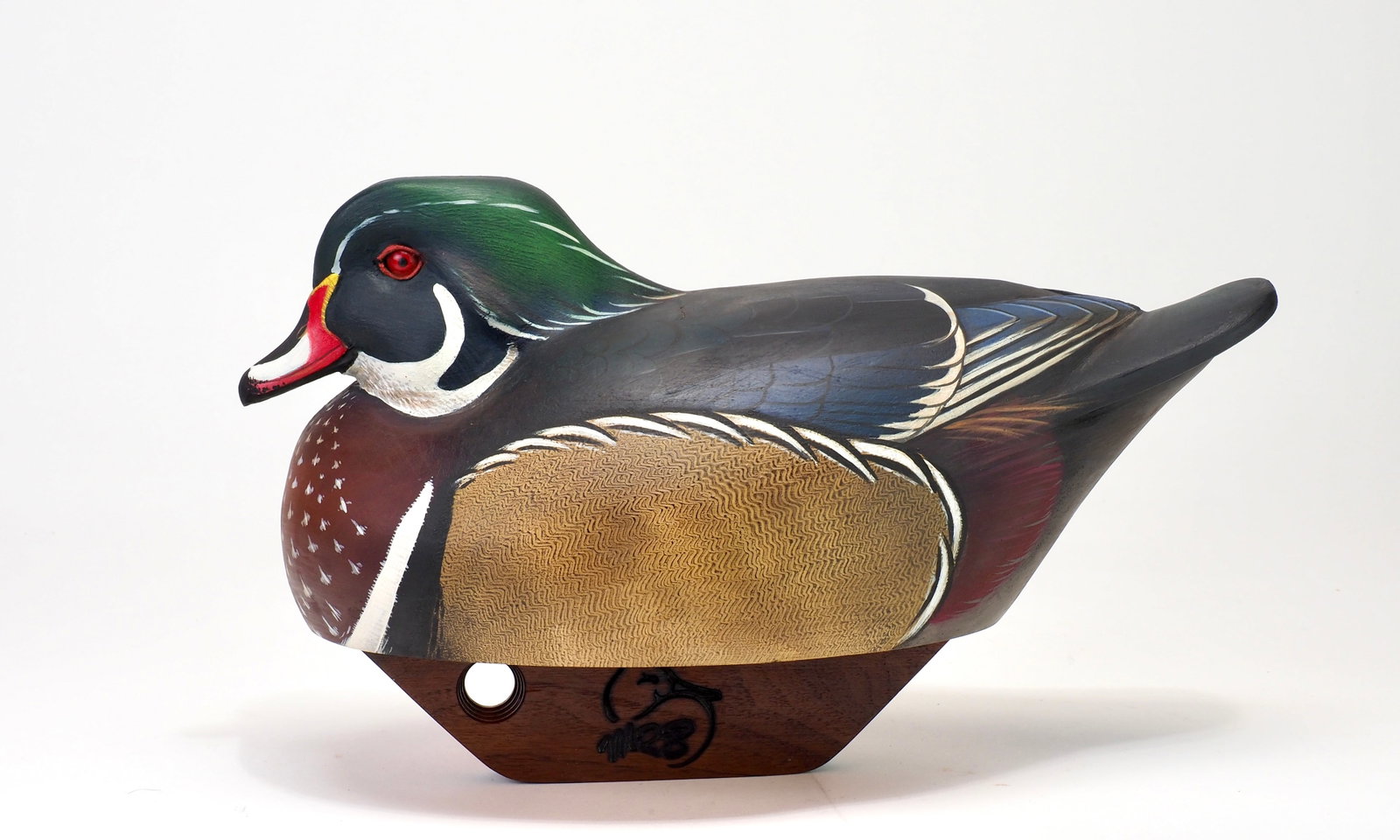 Michael Braun - Wood Duck Drake: Michael R. Braun New Jersey 12.5" long Tucked resting head with glass eyes and a carved bill. Smooth body with slightly relief carved wing tips. Comb feather paint on the sides. Branded on the