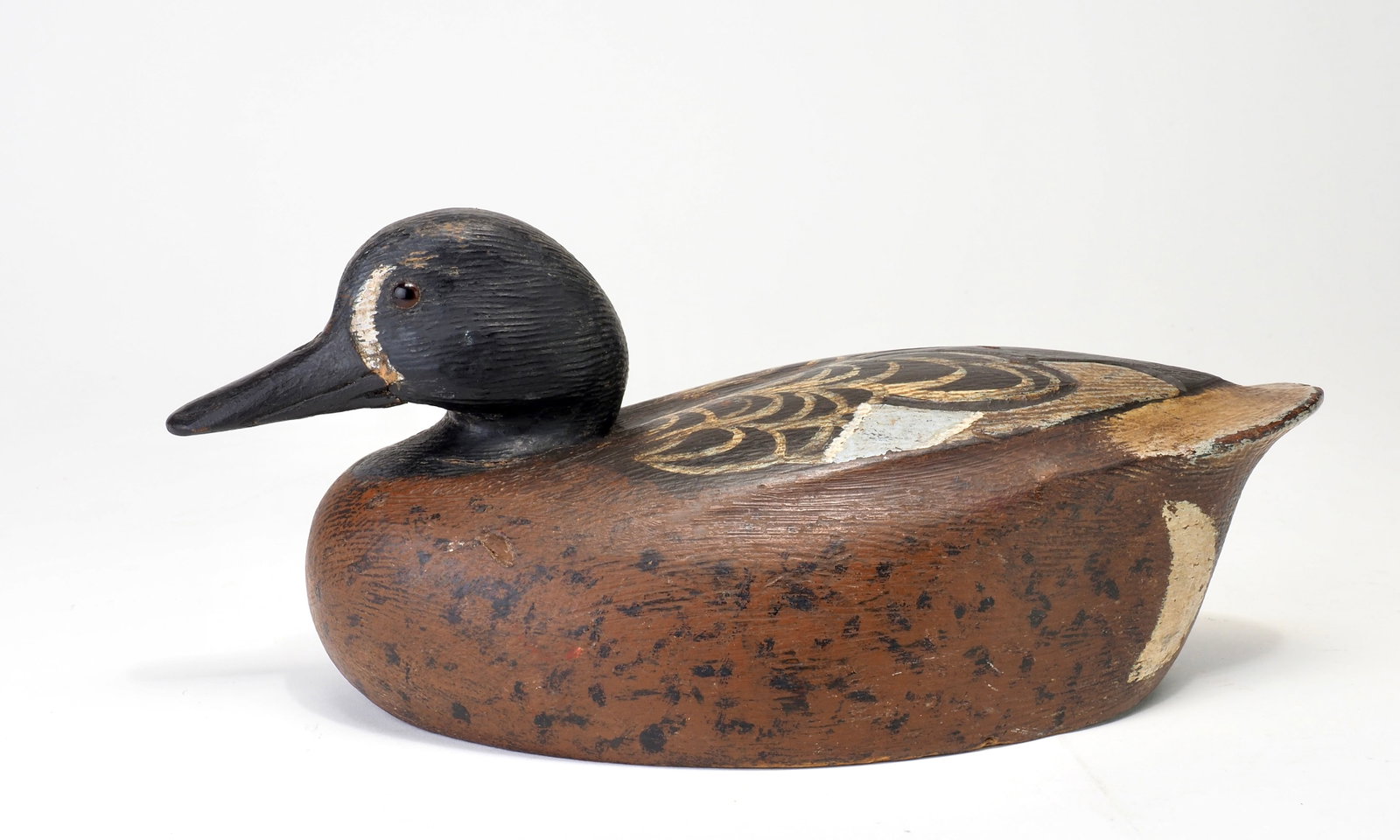 Ken Anger - Bluewing Teal Drake: Ken Anger (1904-1983) Dunnville, Ontario, Canada Early working bluewing teal with a raised body. Rasping across both the head and body with incised feathering in the back. Condition: A mix of working