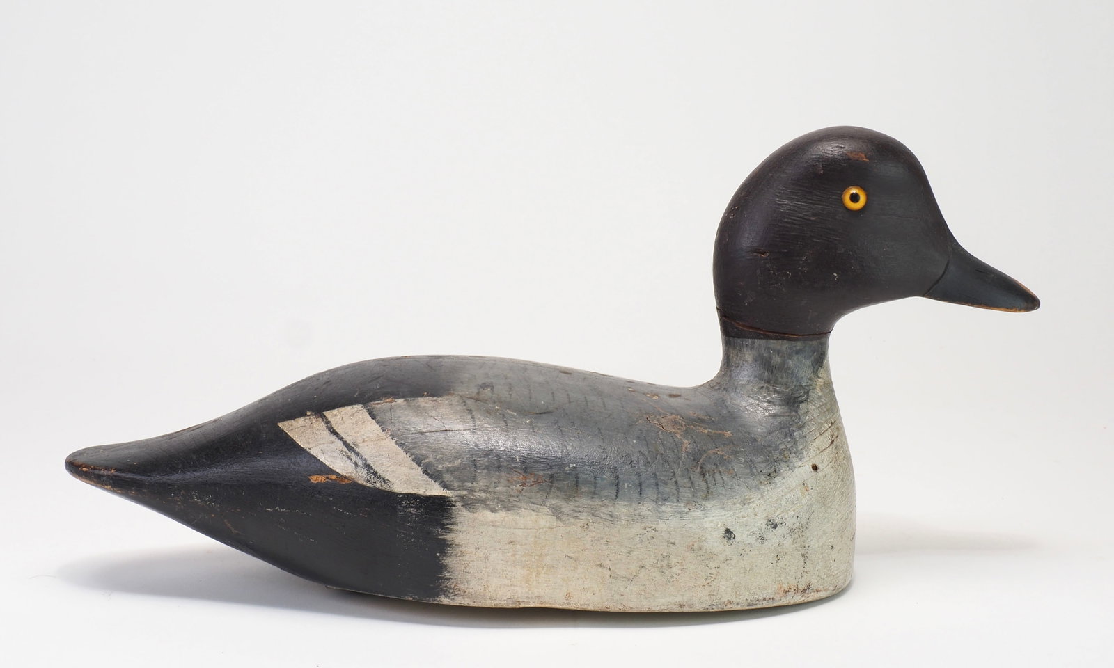 Cyril Heath - Goldeneye Hen: Cyril Heath (1901-1962) Alexandria Bay, NY 14" long Scarce goldeneye hen with an alert head and incising where the face and bill meet. Soft feathered paint on the body. Condition: Original with
