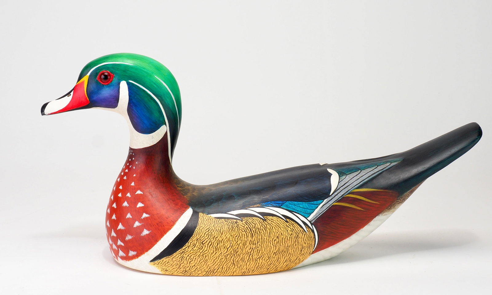 Bob Kerr - Published Wood Duck with Book: Robert G. Kerr (1935-2025) Smith Falls, Ontario, Canada 16.75" long Kerr began carving decoys in the 1950s, initially making working birds for his own hunting. He attended his first decoy competition