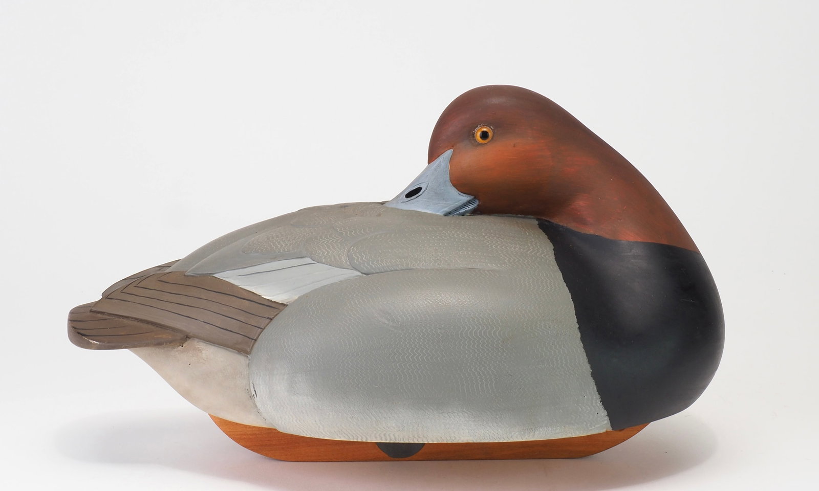 Bob Kerr - Preening Redhead Drake: Robert G. Kerr (1935-2025) Smith Falls, Ontario, Canada 12" long Kerr began carving decoys in the 1950s, initially making working birds for his own hunting. He attended his first decoy competition in