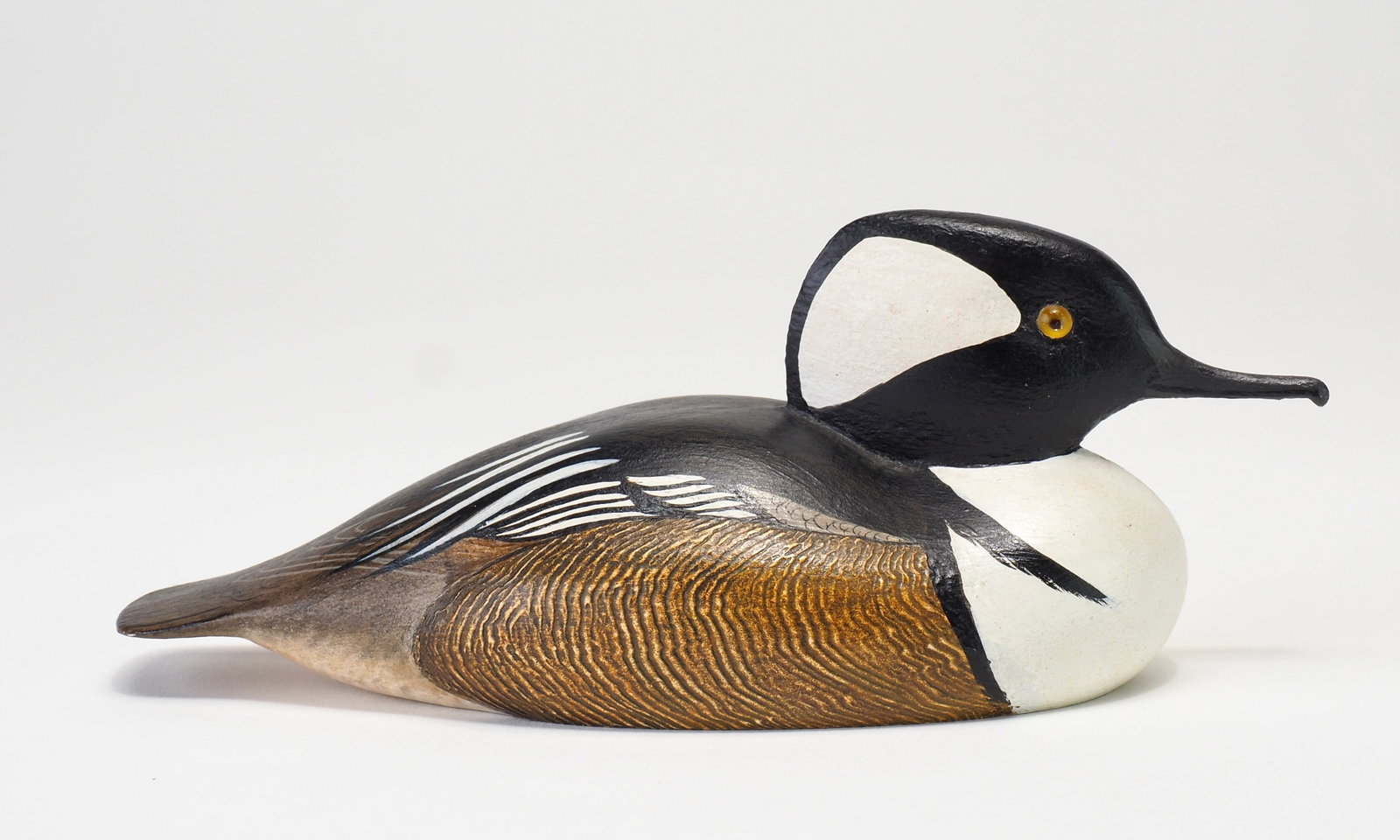 Bob Kerr - Miniature Hooded Merganser Drake: Robert G. Kerr (1935-2025) Smith Falls, Ontario, Canada 5.5" Tight comb feather paint with tiny glass eyes and carved bill detail. Signed and dated ay 1972 Condition: Excellent and original