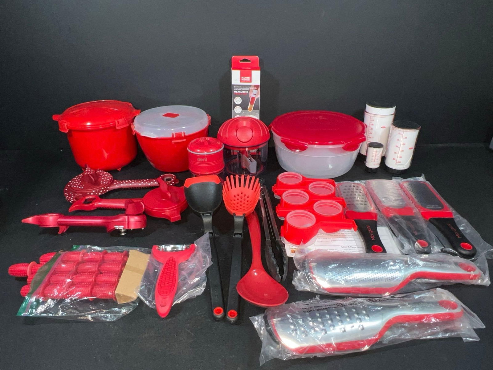 Red Kitchen Tools & Utensils: Sistema bowls, Deni chopper, Kuhn Ricon measuring tools, Kuhn Rikon chopper, Lock & Lock nesting bowls, OXO adjustable measuring cups, set of five Microplate graters, a set of five Mark Charles Mi