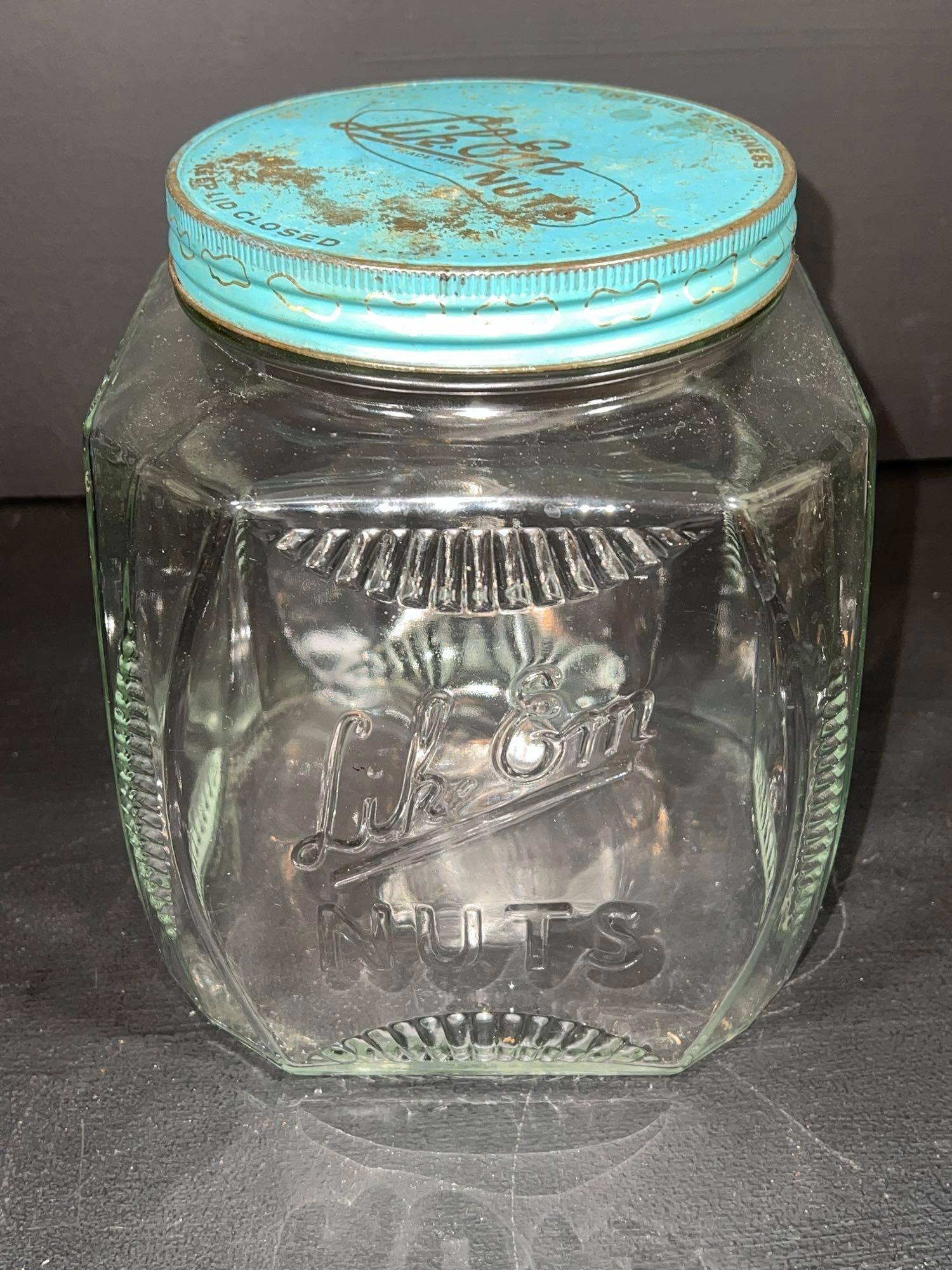 Vintage Lik-em Nuts Counter Jar: Vintage Lik-em Nuts counter jar with lid, 8” high x 6.5” x 6.5” No chips or cracks, some paint loss on the lid.