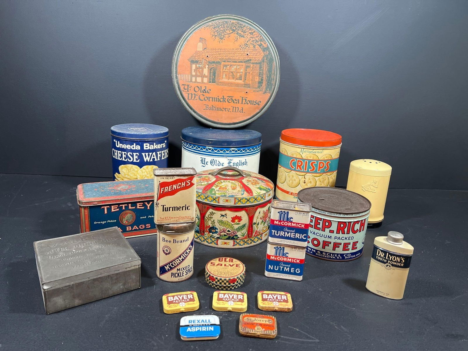 Vintage Advertising Tins: Twenty vintage advertising tins to include a Ye Olde McCormick Tea House biscuit tin 10” in diameter, a Ye Olde English Mints tin, a Uneeda Cheese Wafers tin, a Maryland Crisps tin, a Dutch Clea
