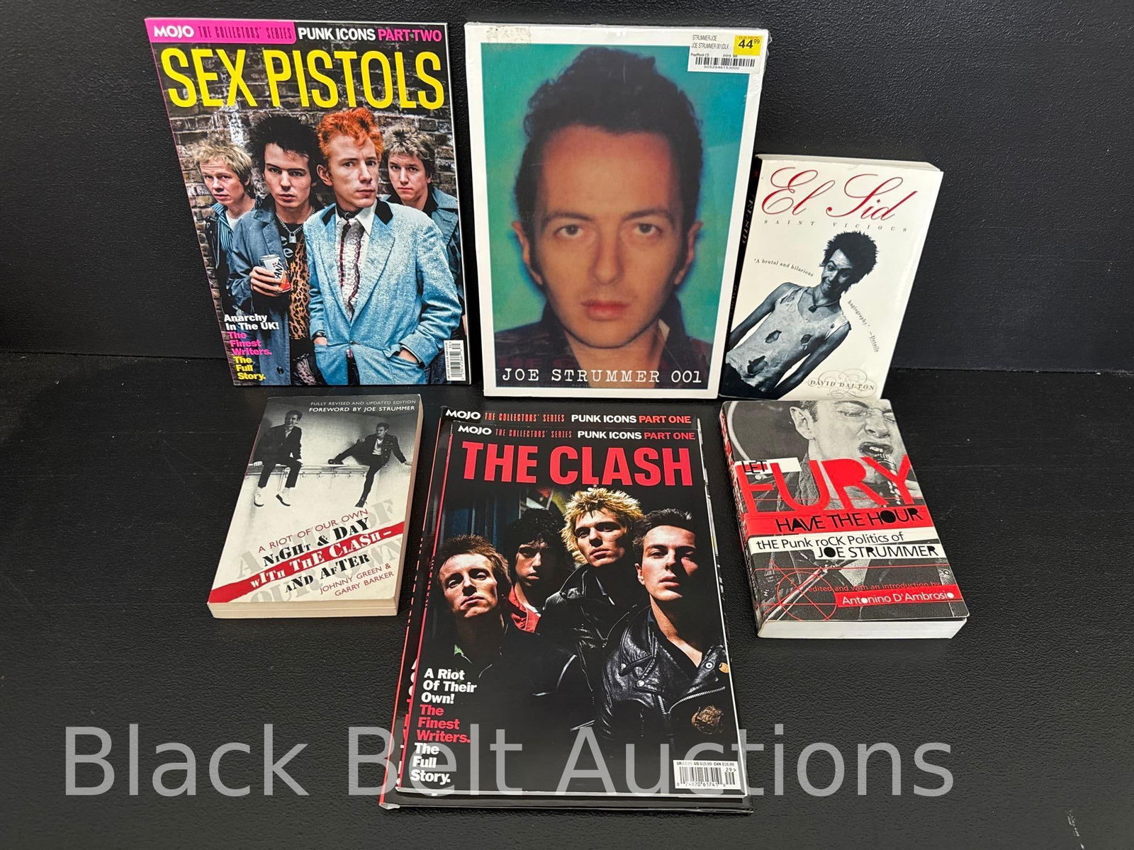 The Clash & Sex Pistols Grouping: Lot description: To include a Mojo Punk Icons folder and magazine of The Clash, “A riot of our own Night and Day with The Clash and After” by Johnny Green & Gary Barker, stated second