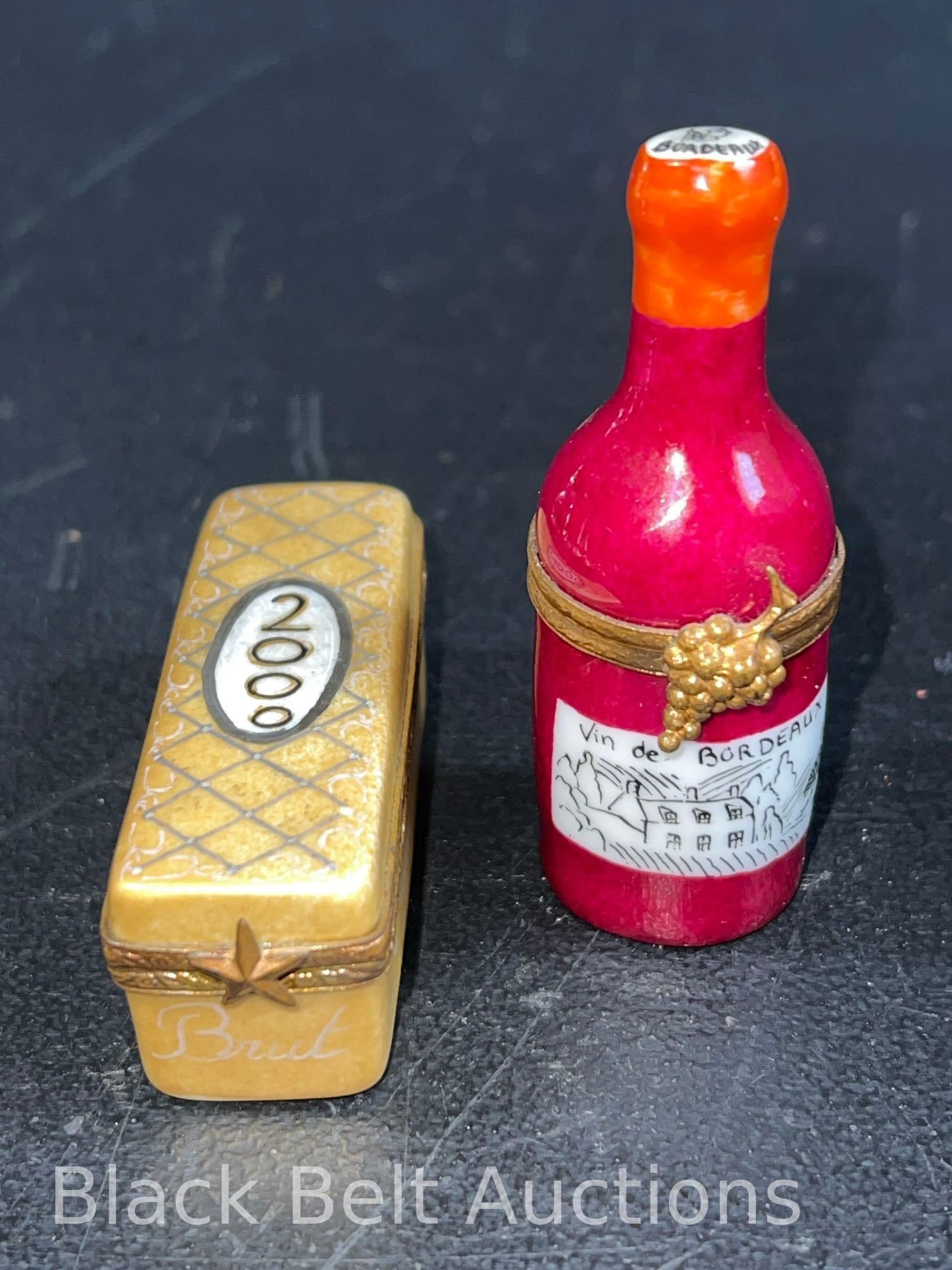 Two Limoges Wine Champagne Trinket Boxes: Lot description: Two vintage Limoges hand painted porcelain trinket boxes to include: A Year 2000 Champagne cask, signed, 2 1/2 inches long, 1 inch high and 3/4 inches wide. A bottle of Vin de Bordeau