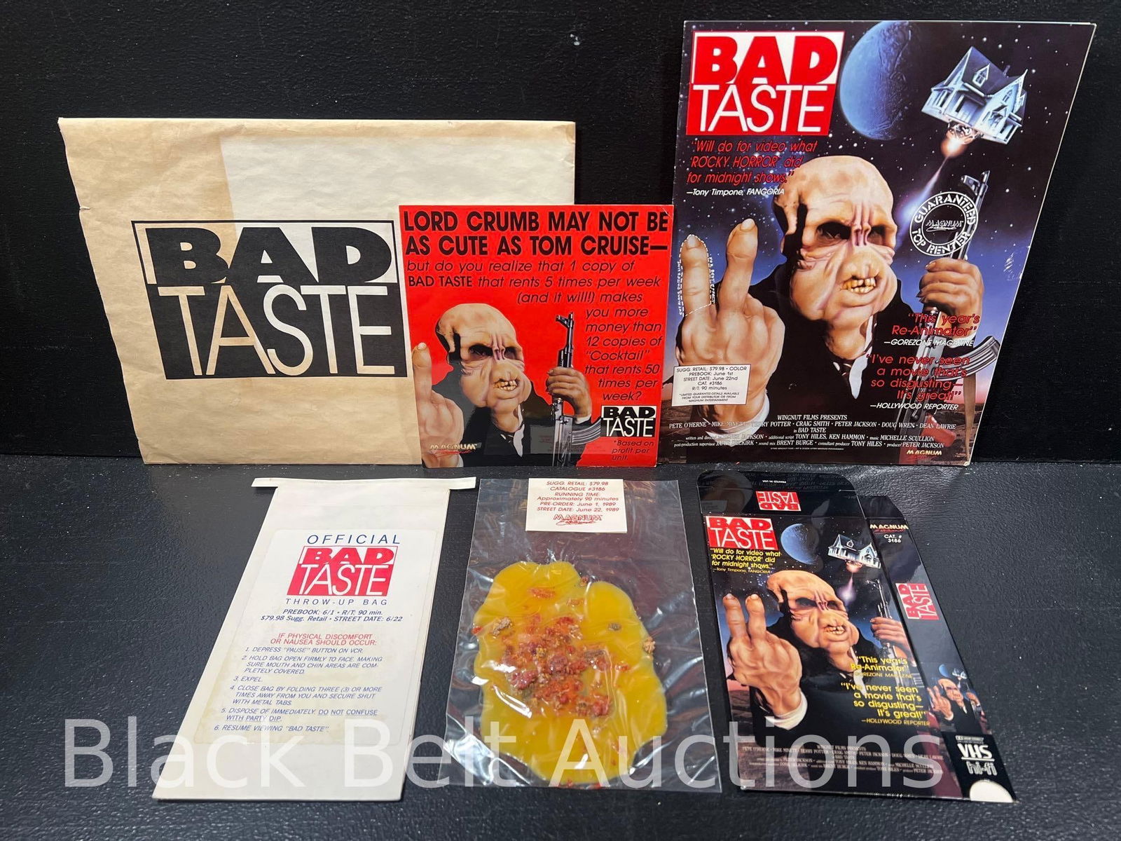 Bad Taste Movie Promotional Packet and More: Lot description: Original 1989 video store promotional materials for the film "Bad Taste" that includes a packet with a flat vhs tape box for the movie, an official "Bad Taste" Throw-Up Bag (again