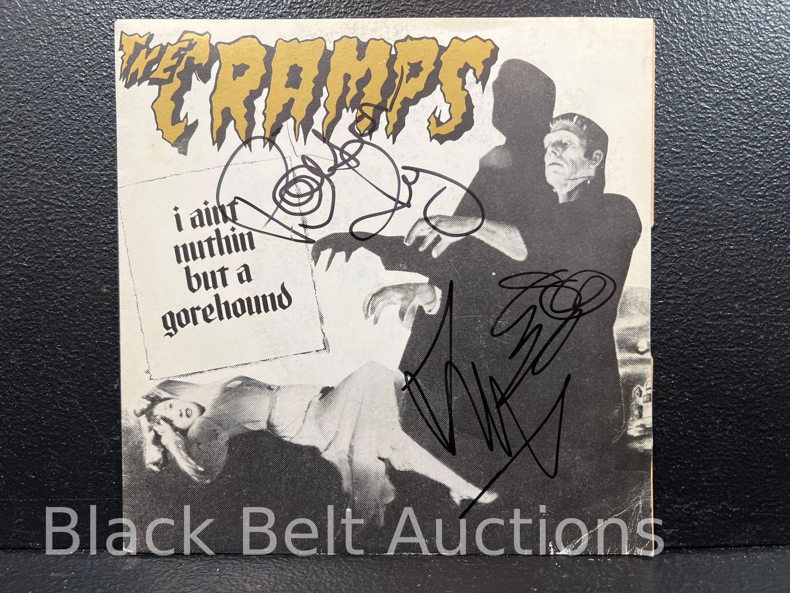 The Cramps 45 Signed by Lux and Ivy: Lot description: The Cramps "I Ain't Nuthin But a Gorehound" / "Weekend on Mars" - a French pressing on the New Rose label on WHITE VINYL. The jacket is creased and has edge and corner wear, the