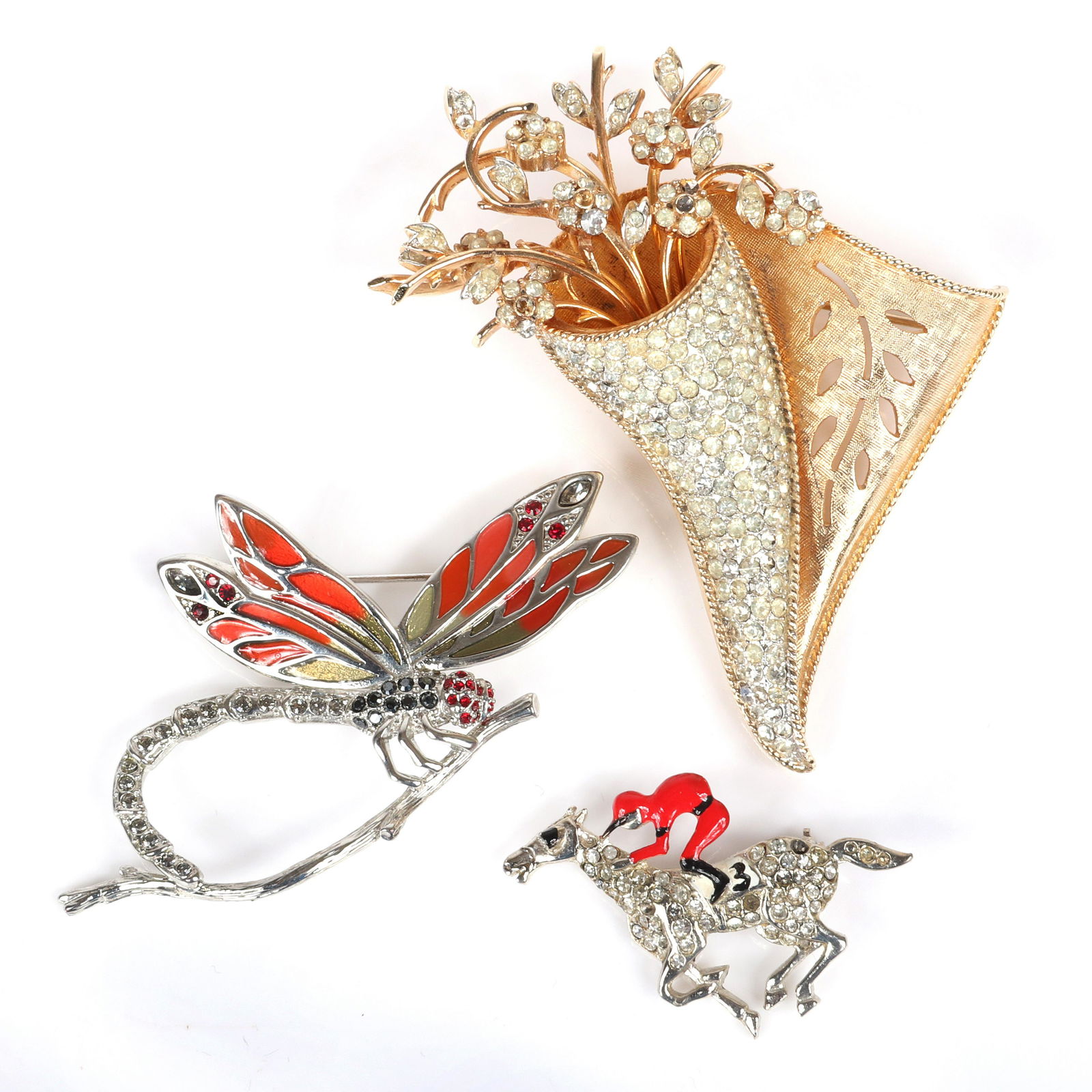 Three vintage pins: Judith Leiber enamel and pave: Three vintage pins: Judith Leiber enamel and pave dragonfly, pave and red enamel racing #3 jockey and Francoise pave cornucopia flower basket. 3"H x 2 3/4"W (cornucopia)