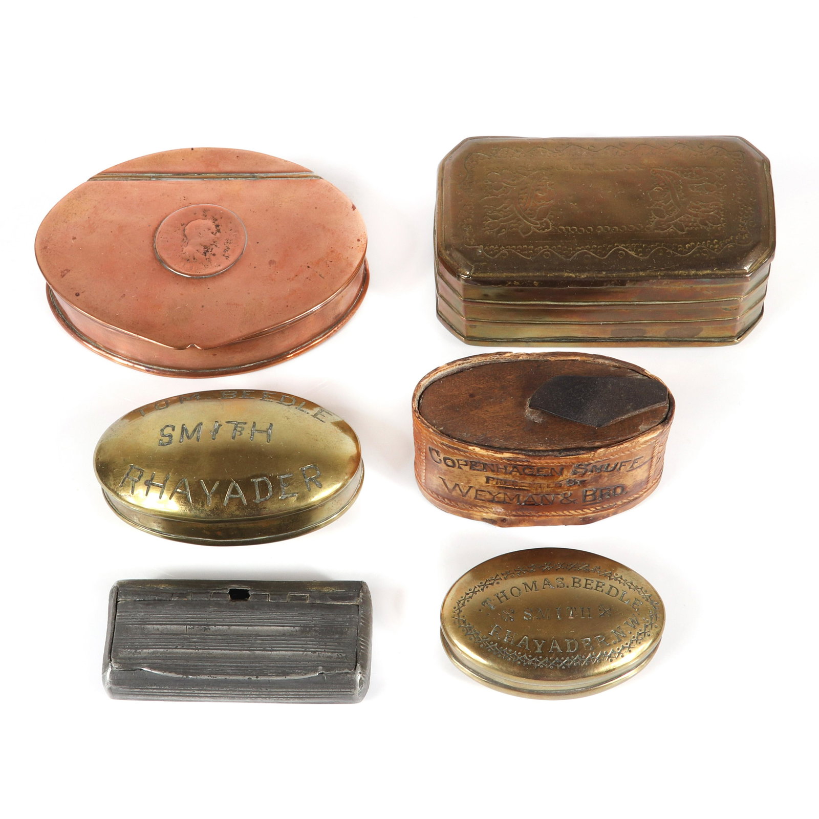 Six antique snuff boxes: two brass boxes with original: Six antique snuff boxes: two brass boxes with original owner's name, trade and address; pewter ribbed box, Copper box with embedded Britannia coin, Weyman & Bro Copenhagen Snuff., Also includes brass 