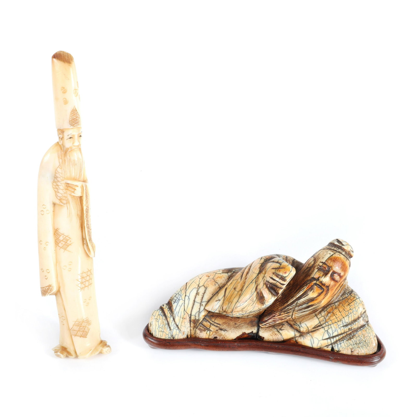 Two antique Asian figural bone carvings, fossil Chinese: Two antique Asian figural bone carvings, fossil Chinese reclining male figure on wood base, and standing Immortal., 2"H x 3 1/4"W one
