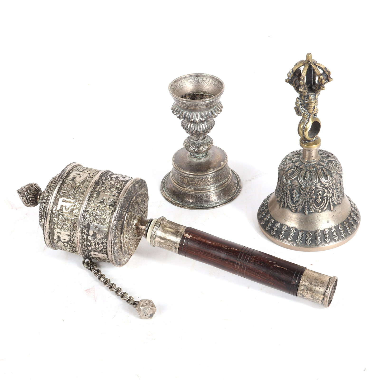 Chinese Tibetan Himalayan Nepalese ceremonial silver: Chinese Tibetan Himalayan Nepalese ceremonial silver items; Buddhist prayer wheel, bell, and candleholder or drinking vessel., 12 1/2"W