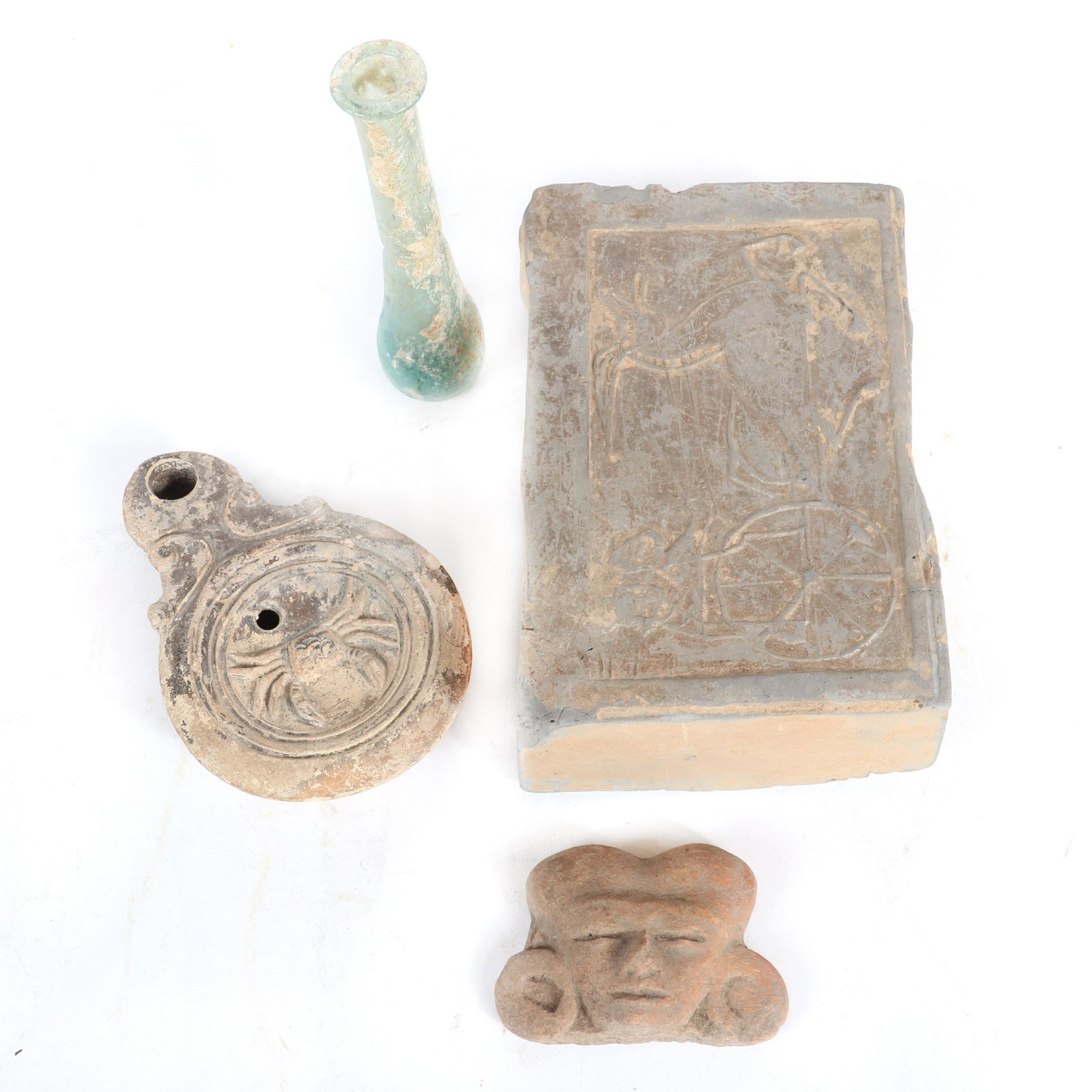 Collection of 4 ethnographic antiquities / relics;: Collection of 4 ethnographic antiquities / relics; Roman glass vial and pottery oil lamp, Pre Columbian / Mayan terra cotta fragment head of a god, and architectural earthenware brick with bas relief 