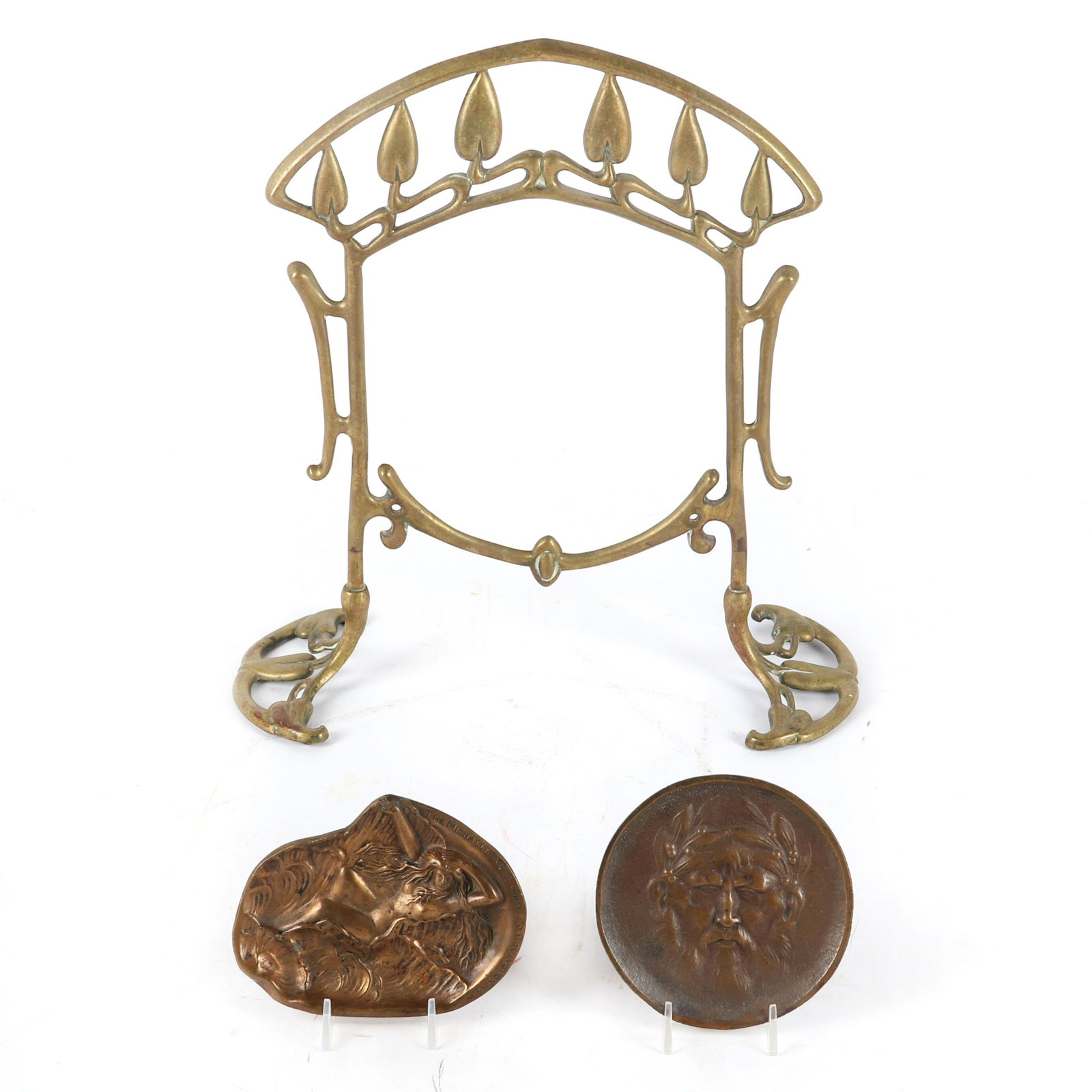 Three Art Nouveau bronze items; standing French picture: Three Art Nouveau bronze items; standing French picture frame with foliate motif along with two trays, The Michaels Art Bronze, Covington KY advertiser with female nude and face of Green Man in relief