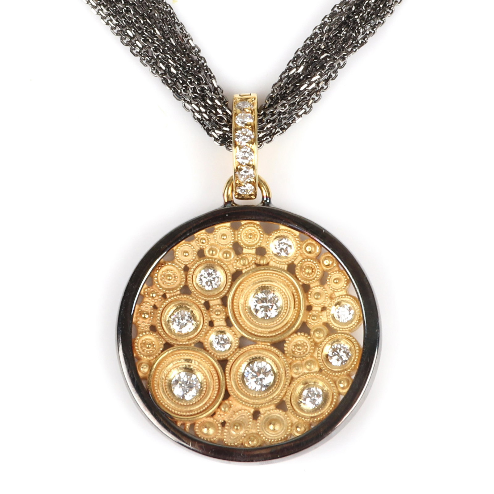 18K yellow and black gold and diamond circle pendant on: 18K yellow and black gold and diamond circle pendant on multi 10 strand stamped 18K black gold chain. Contains 10 diamonds in pendant and 6 accents on hinged clasp. 21" longest length, 7/8" diam. (pen