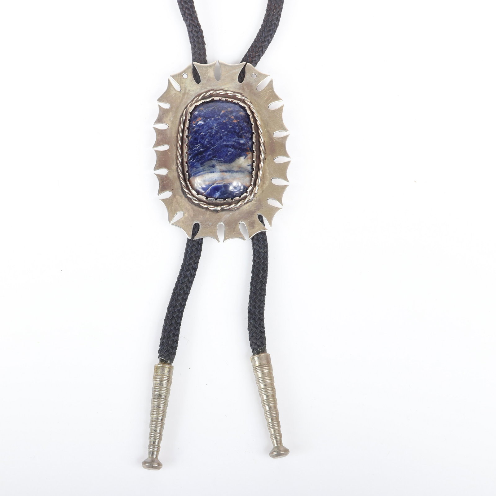 Mildred Ball American Modernist bolo tie with a large: Mildred Ball American Modernist bolo tie with a large sterling clasp with scalloped edge, rope detail and large blue sodalite cabochon on black woven cord. Ball was a Mid-Century jeweler, enamelist an