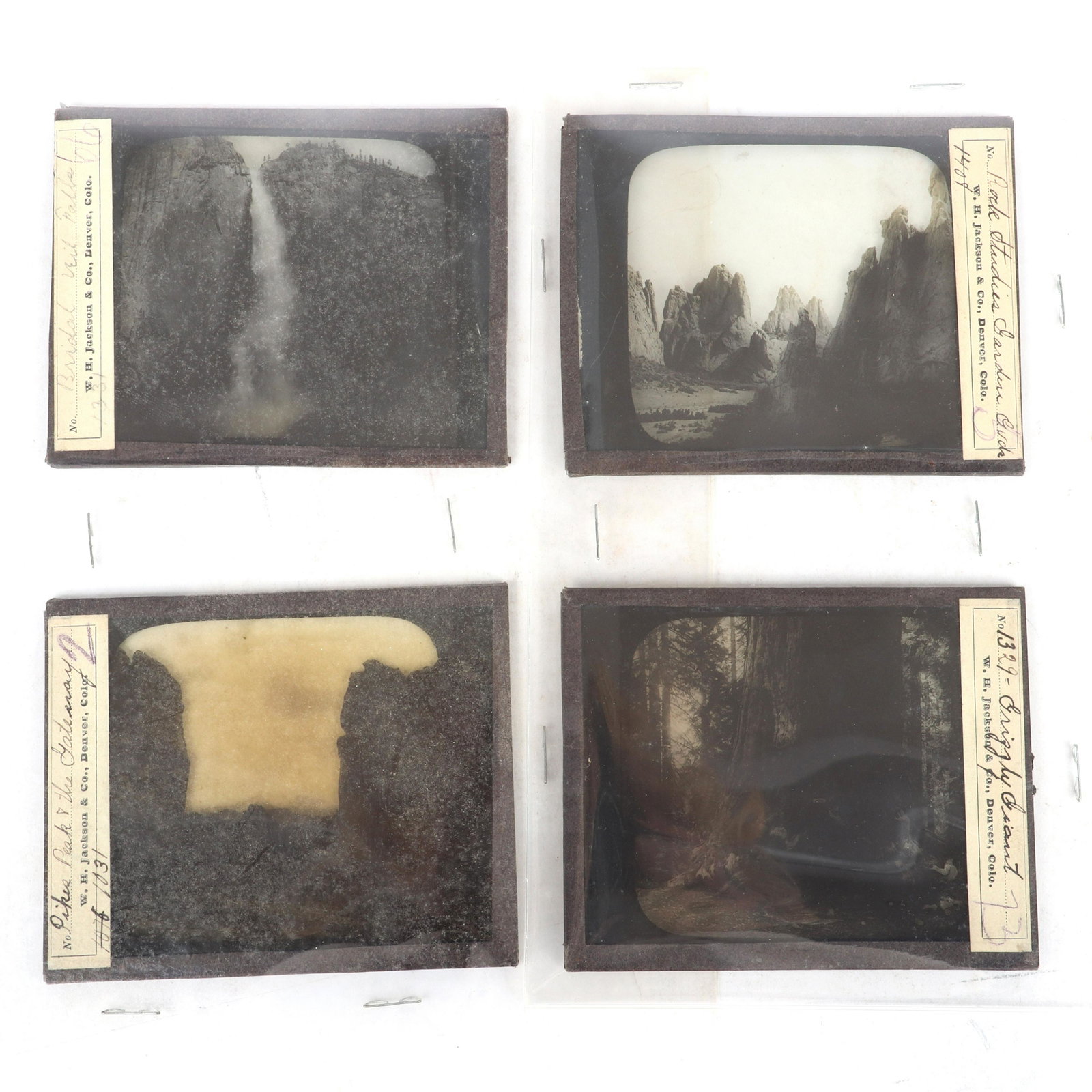 Four glass negatives W.H. Jackson Photo. & Pub. Co.,: Four glass negatives W.H. Jackson Photo. & Pub. Co., Denver Colo, CA 19th Century, Rocky Mountain Scenery including hand-written labels for Pikes Peak & the Gateway, Bridal Veil Falls Also includes Ro