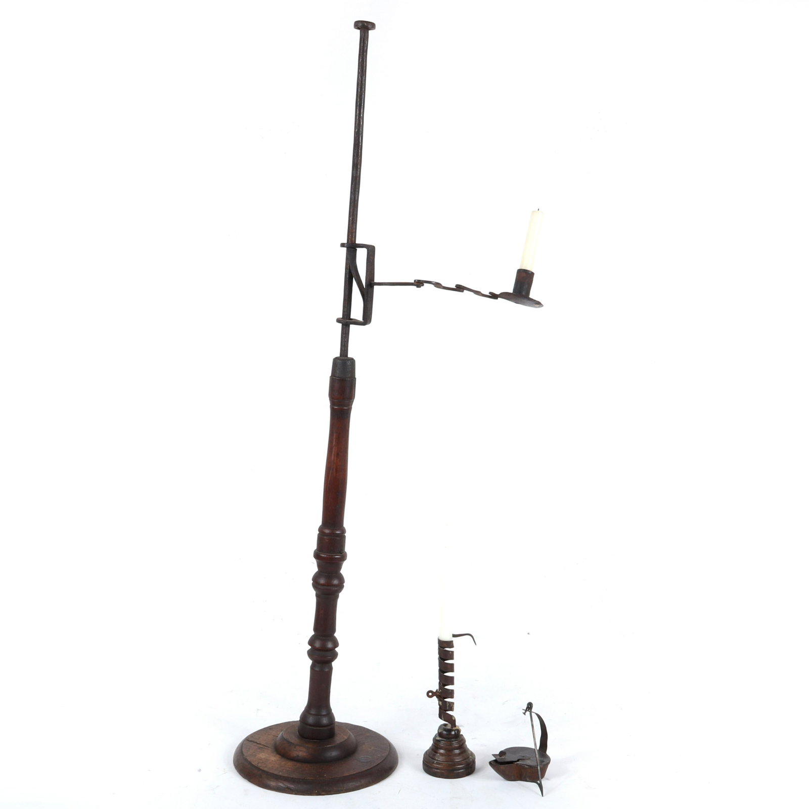 Collection of 3 antique American iron primitives push: Collection of 3 antique American iron primitives push up candle holder, whale oil lamp, and floor standing candle stand with adjustable arm on wood base. Wood base is loose at socket, and needs some m
