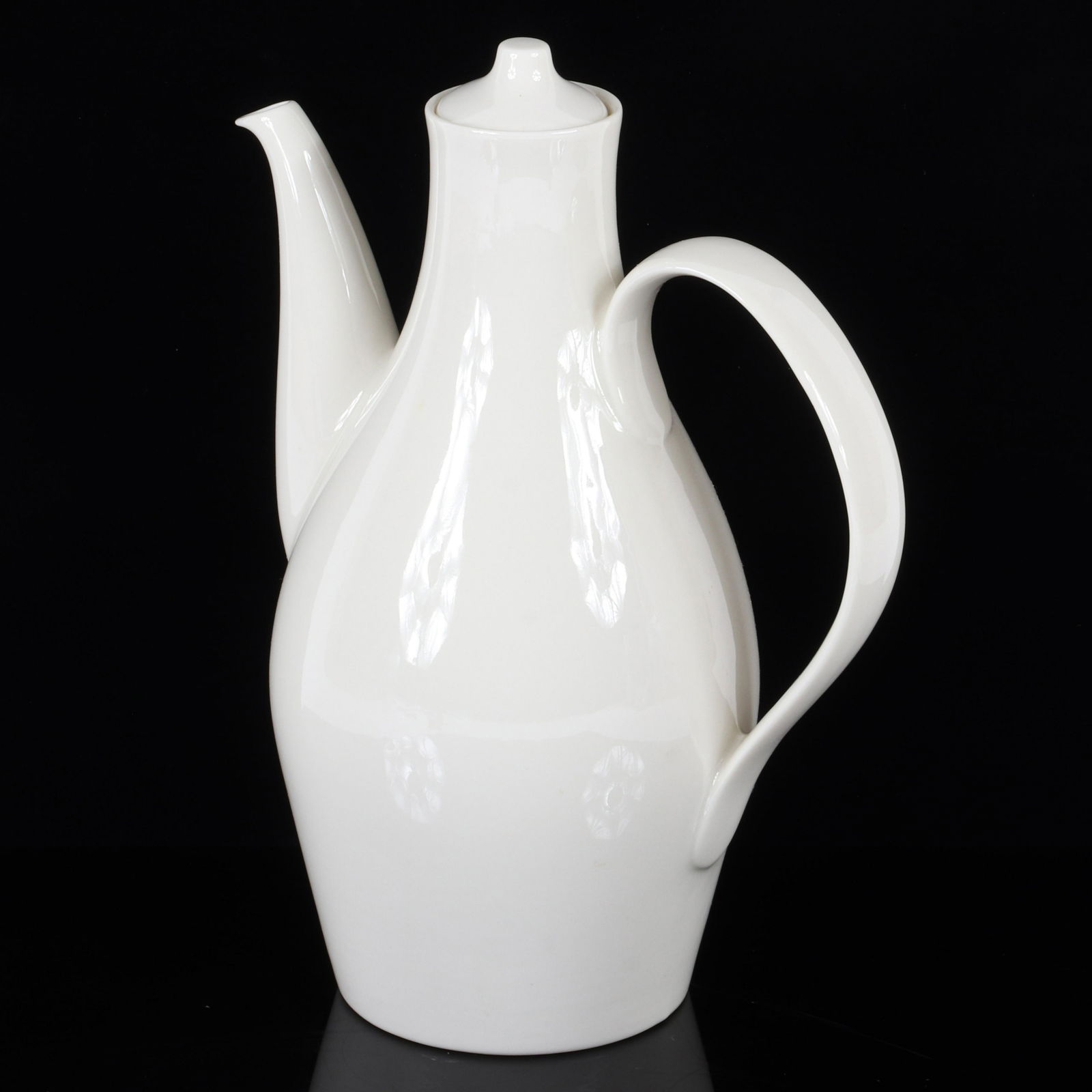 Eva Zeisel white ceramic wide handled pitcher with: Eva Zeisel white ceramic wide handled pitcher with conical lid. 10 1/2"H