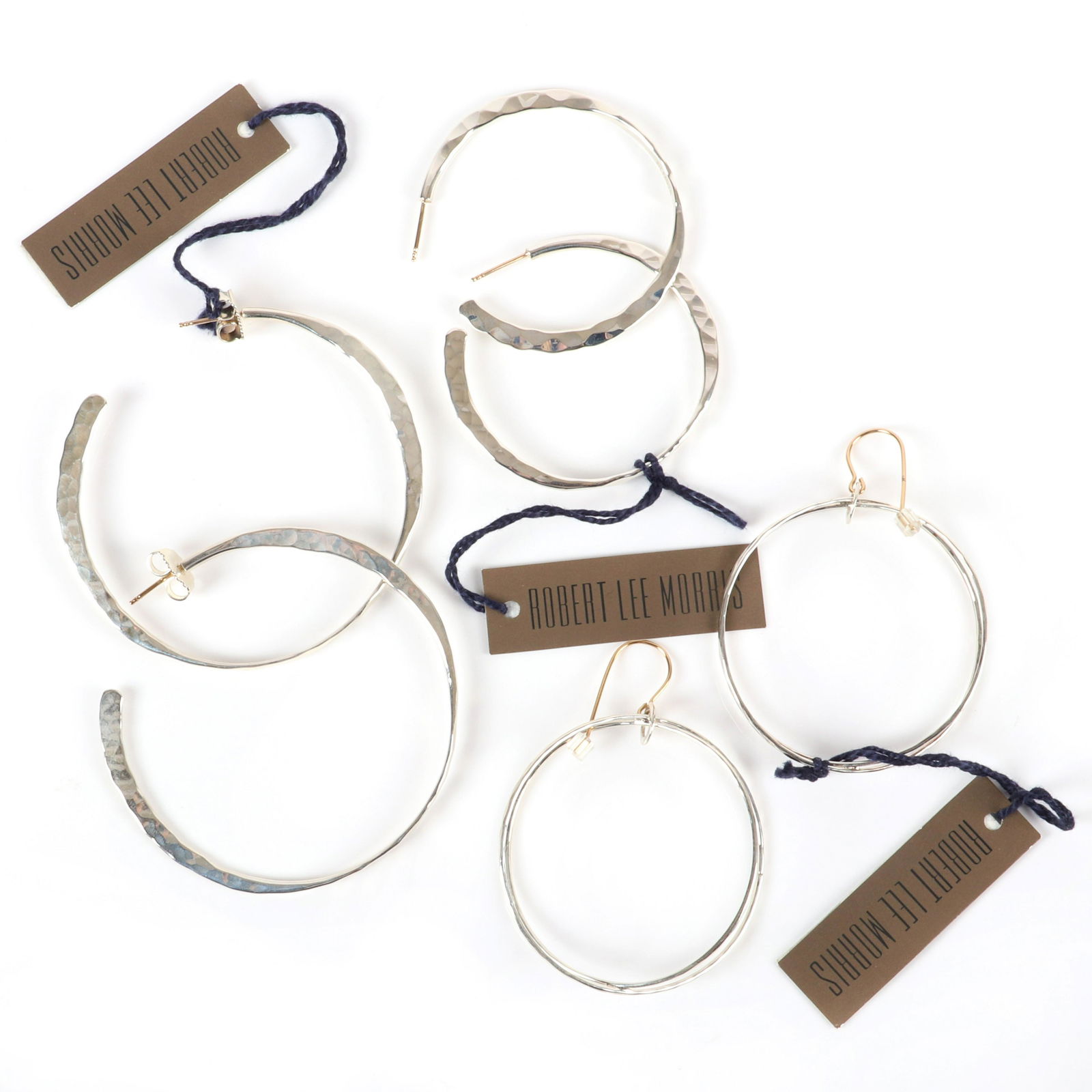 Robert Lee Morris RLM three pairs of sterling silver: Robert Lee Morris RLM three pairs of sterling silver hoop earrings: double crossover, hammered hoops, two pair of hammered silver hoops, with 14K gold hooks/posts, marked RLM 925, new old stock with o