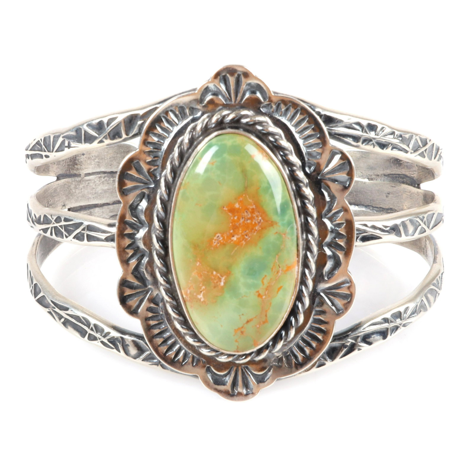 Native American Indian TRT heavily tooled sterling: Native American Indian TRT heavily tooled sterling silver hammer work bracelet with large oval green turquoise central stone. Marked Sterling Silver TRT Hand Made. 2 1'8"inner width, 2"W (at top wides