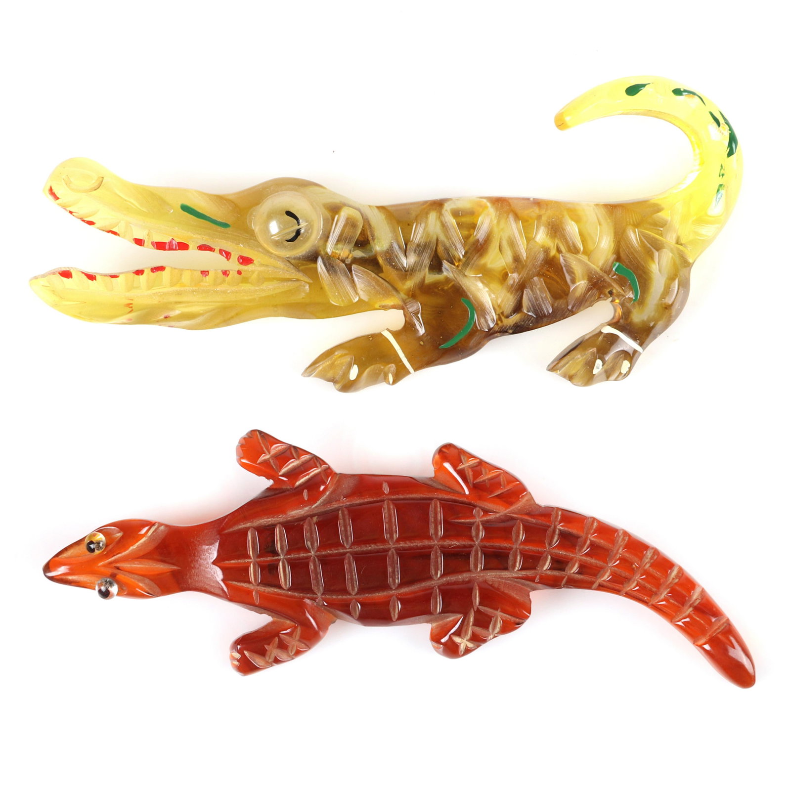 Two Bakelite carved figural crocodile alligator: Two Bakelite carved figural crocodile alligator brooches. 2" H, 4" W (largest)