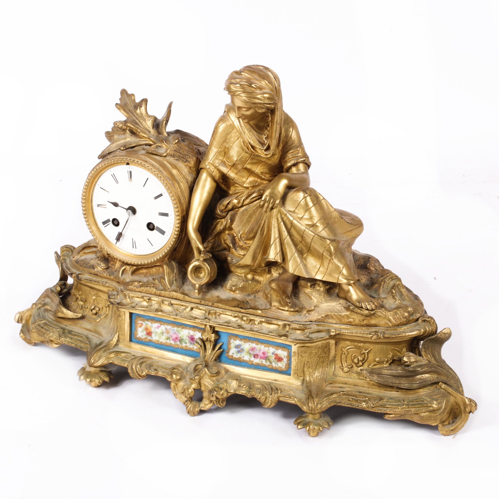 French Gilt Bronze and Sevres Porcelain Neoclassical: French Gilt Bronze and Sevres Porcelain Neoclassical figural mantel clock. Circa 1900, white porcelain dial with Roman numeral markers, gilt bronze figural case depicting a seated woman with water urn