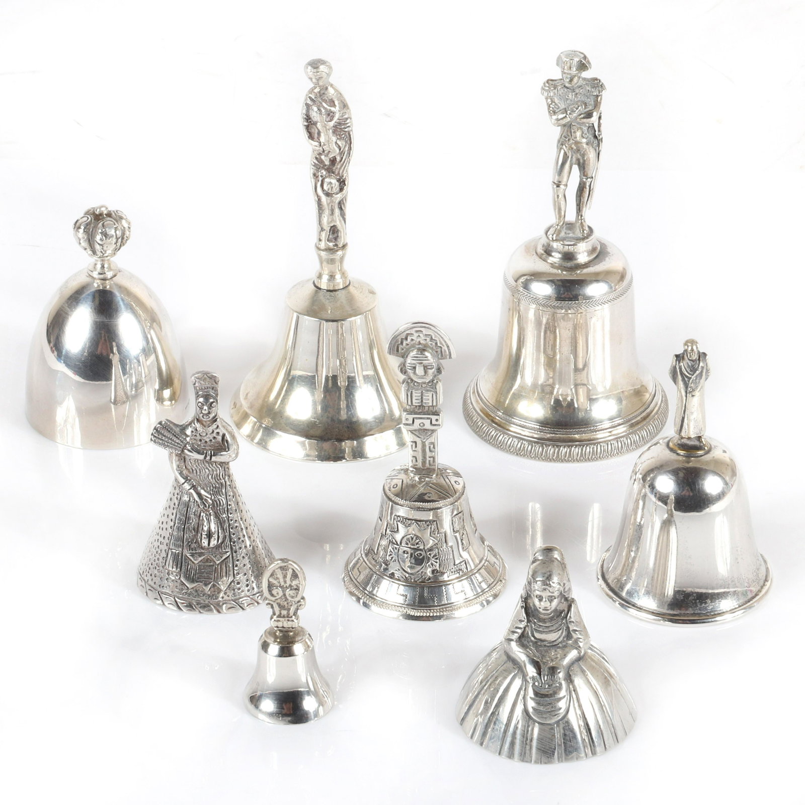 Collection of eight antique Victorian sterling silver: Collection of eight antique Victorian sterling silver hand bells, many with figural handles. 900 silver mother with children, Peruvian woman with fan and Incan God marked 925, 800 silver Chilean bell 