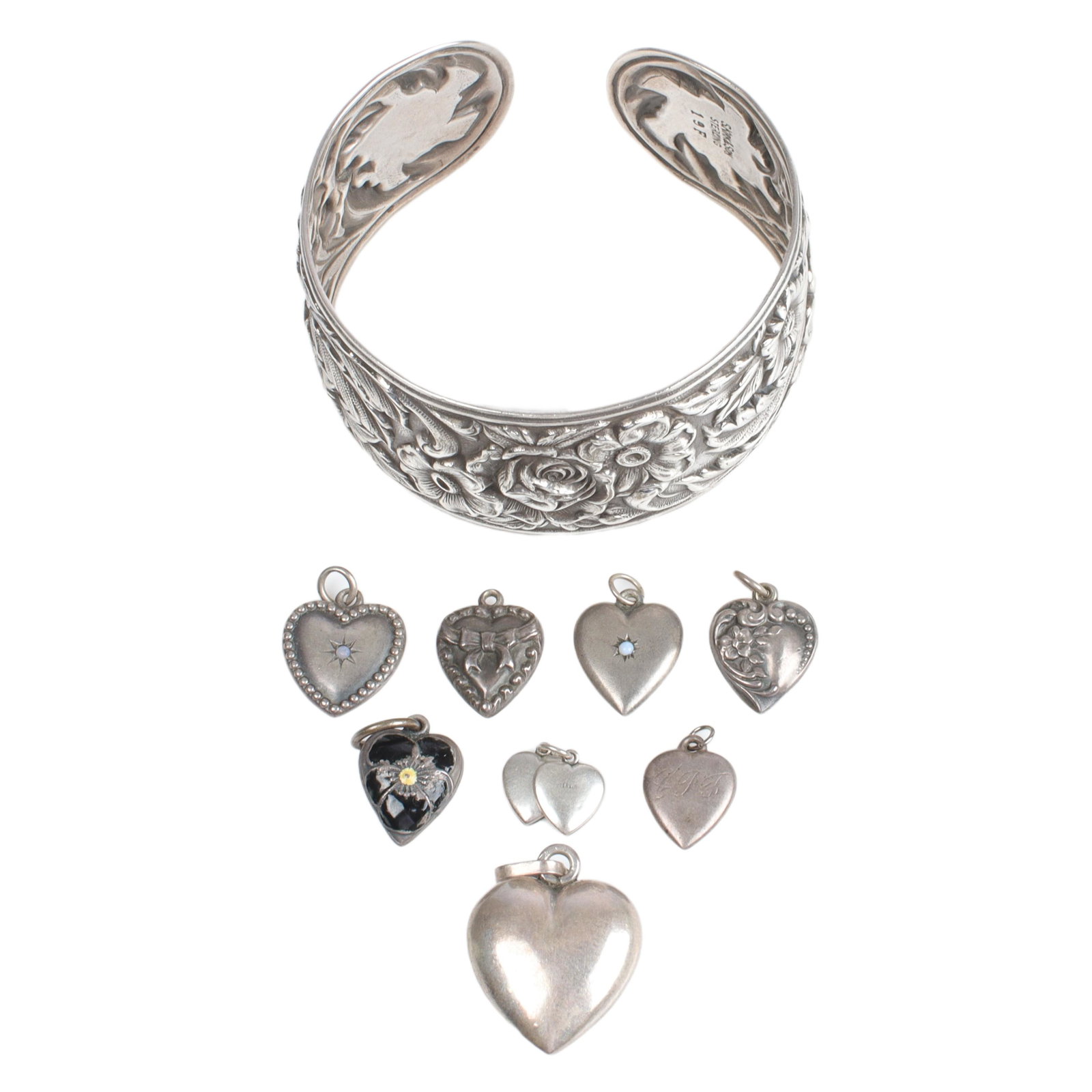 Sterling estate group: S. Kirk & Sons repousse cuff and eight sterling heart charms. 2 3/8"inner W: Sterling estate group: S. Kirk & Sons repousse cuff and eight sterling heart charms. 2 3/8"inner W