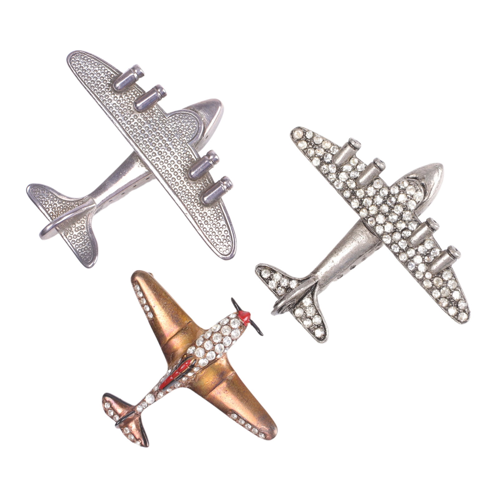 Three vintage Patriotic costume jewelry airplane pins: Trifari sterling vermeil, sterling plane 2"H: Three vintage Patriotic costume jewelry airplane pins: Trifari sterling vermeil, sterling plane and plain with pave rhinestone details. 2"H x 2 1/4"W (largest)