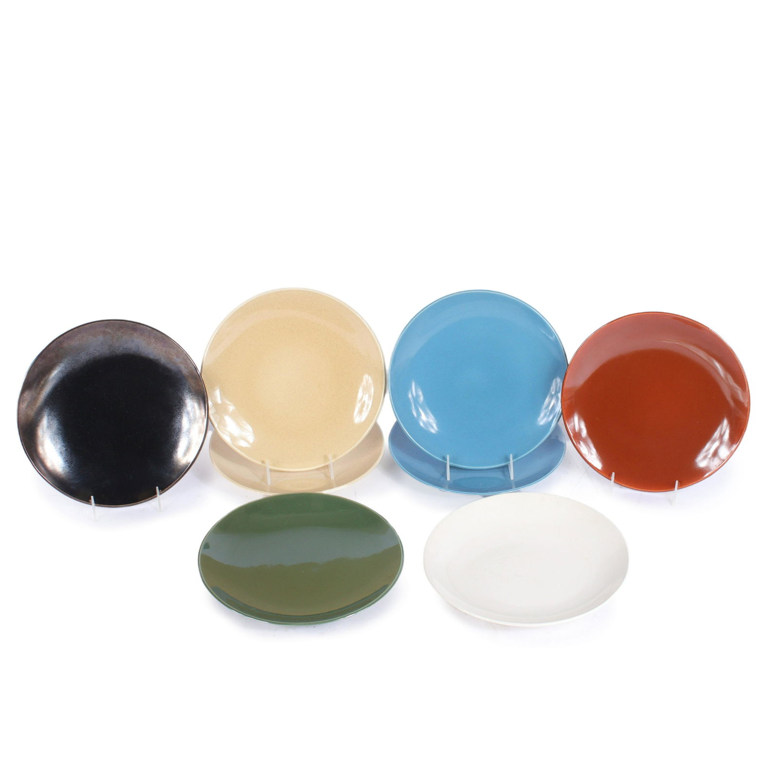 Eva Zeisel Town & Country MCM 8pc dinner plate group: bronze gunmetal plate, rust plate, 10: Eva Zeisel Town & Country MCM 8pc dinner plate group: bronze gunmetal plate, rust plate, 2 sand plates, 2 blue plates, green plate, cream plate. 10 1/2"Diam.