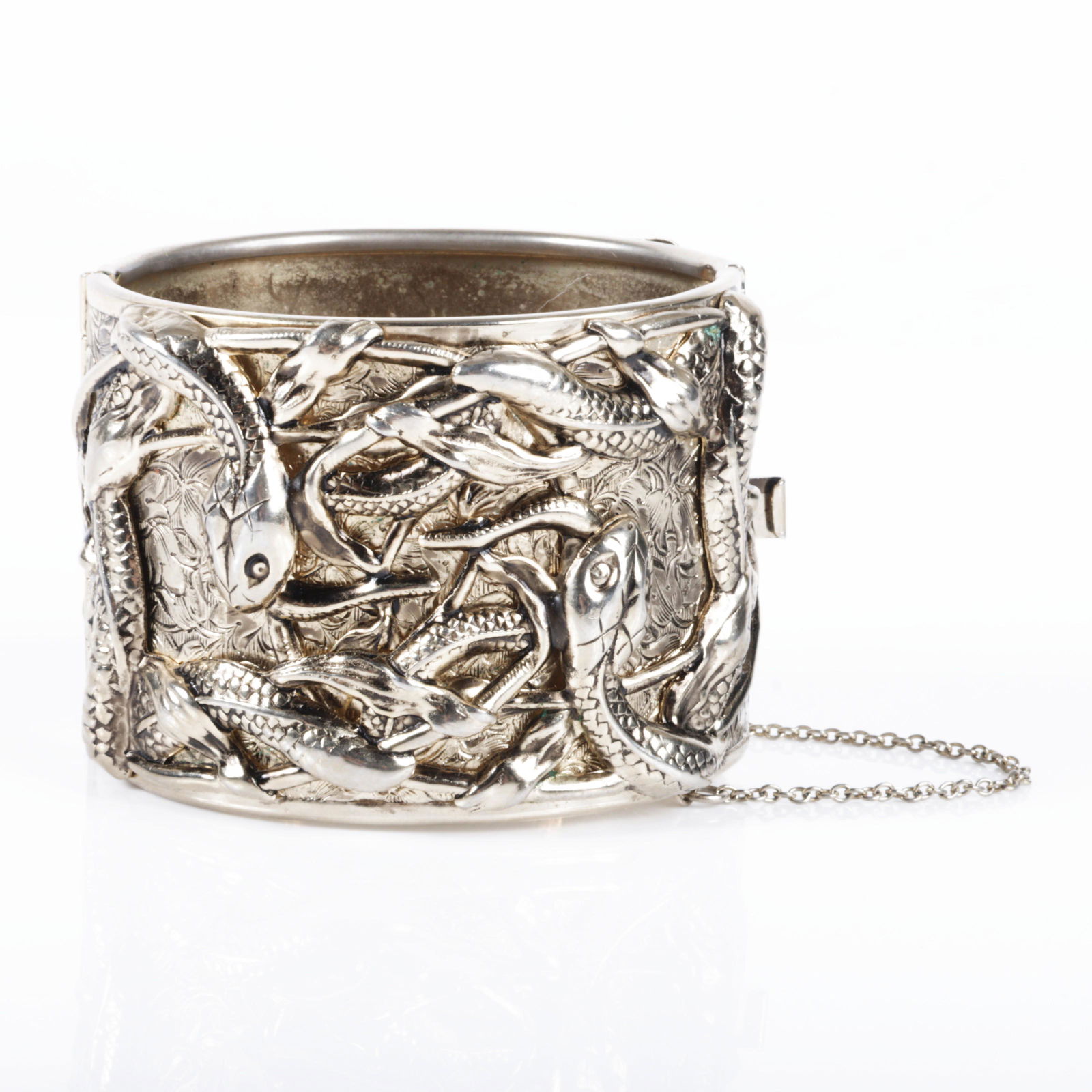 Wide hinged gold wash metal cuff bracelet embossed and applied with layers of repousse snakes / (1 of 6)