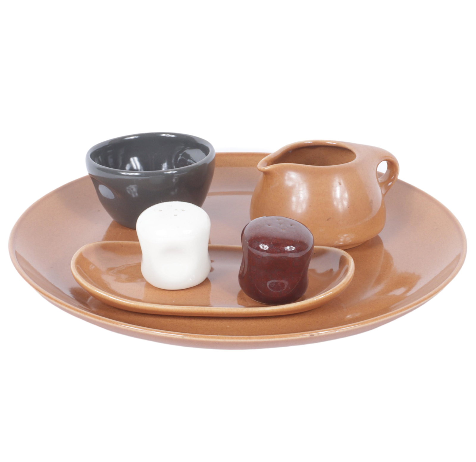 Lot of 6 Russel Wright Iroquois and American Modern dinnerware: stacking cream and sugar, small oval: Lot of 6 Russel Wright Iroquois and American Modern dinnerware: stacking cream and sugar, small oval platter, serving plate, and pinch salt and pepper shakers. 1 1/4"H x 13 1/4"Diam. (serving plate)