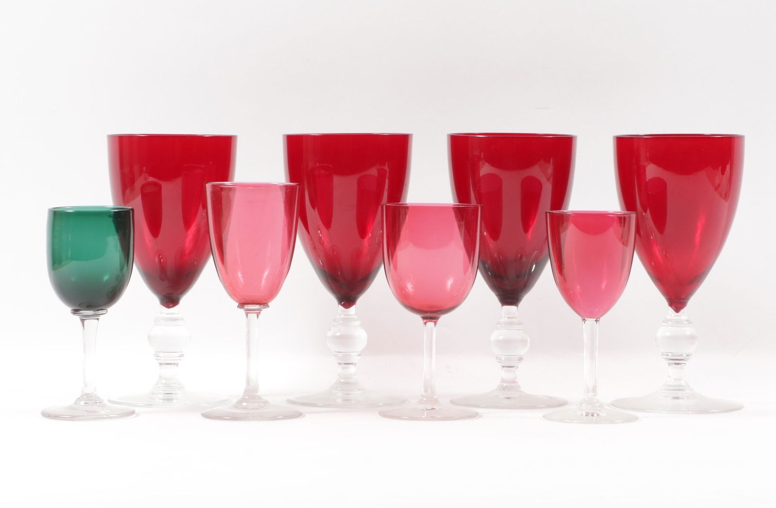 Lot of 8 colored hand blown art glass stemware: 4 ruby red goblets, 3 red cordial glasses, green: Lot of 8 colored hand blown art glass stemware: 4 ruby red goblets, 3 red cordial glasses, green cordial stem. 6 3/8"H x 3"Diam. (largest)