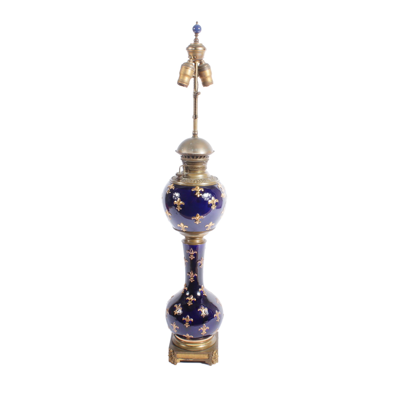 Cobalt blue porcelain gilt fleur de lis banquet oil lamp converted electric. 38"H x 8"W x 8"D: Cobalt blue porcelain gilt fleur de lis banquet oil lamp converted electric. 38"H x 8"W x 8"D