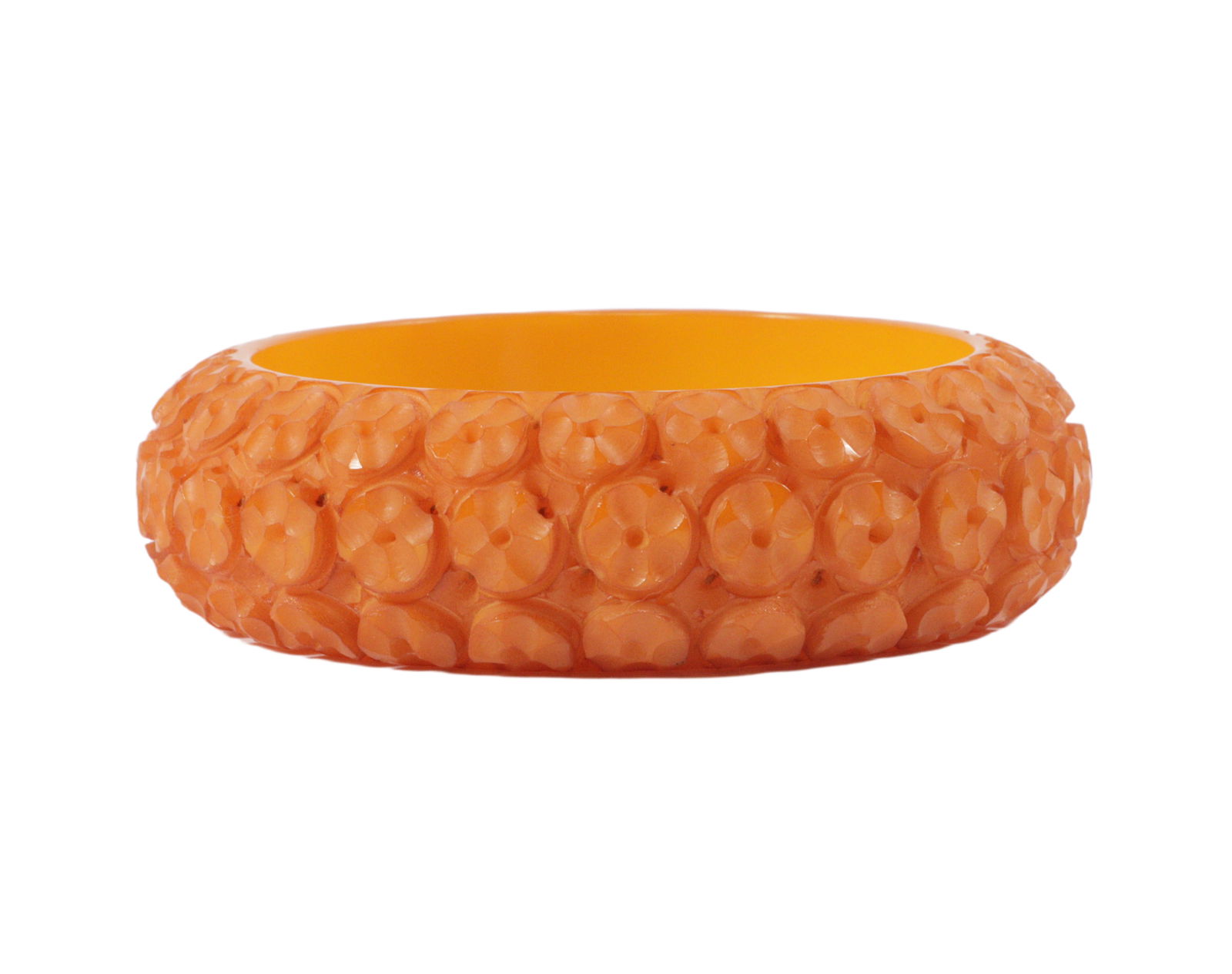 Orange deeply carved Bakelite bangle bracelet: carved with linear lobed concentric circles. (1 of 4)