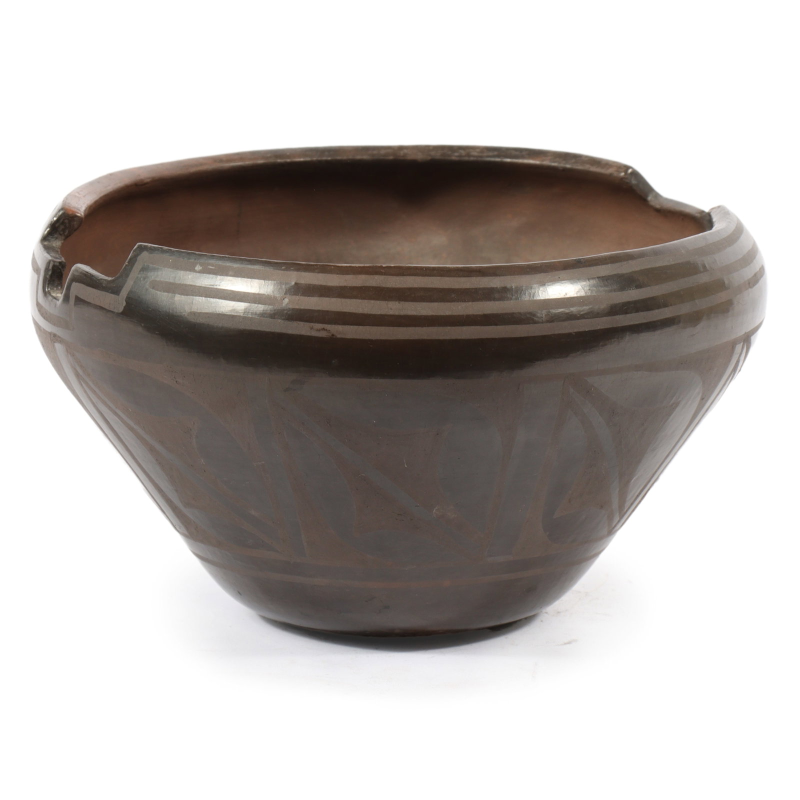 Robert Aguilar Santo Domingo Pueblo Native American burnished blackware pottery bowl with cut out: Robert Aguilar Santo Domingo Pueblo Native American burnished blackware pottery bowl with cut out rim and band pattern design. Signed "Robert Aguilar" with crossed arrows mark under base. 6 1/4?H x 10