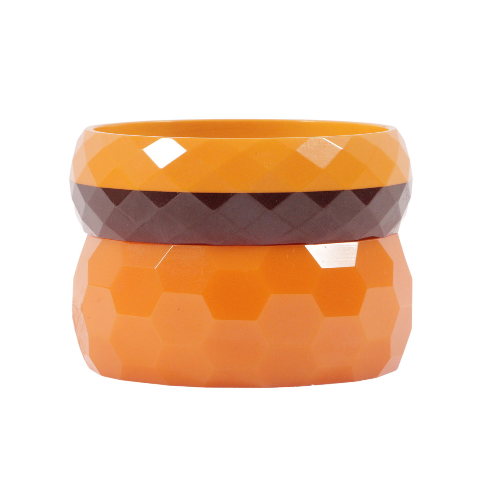 Pair of faceted Bakelite bangle bracelets; butterscotch and brown laminated and wide hex carved.: Pair of faceted Bakelite bangle bracelets; butterscotch and brown laminated and wide hex carved. 3"Diam x 1"H (striped)