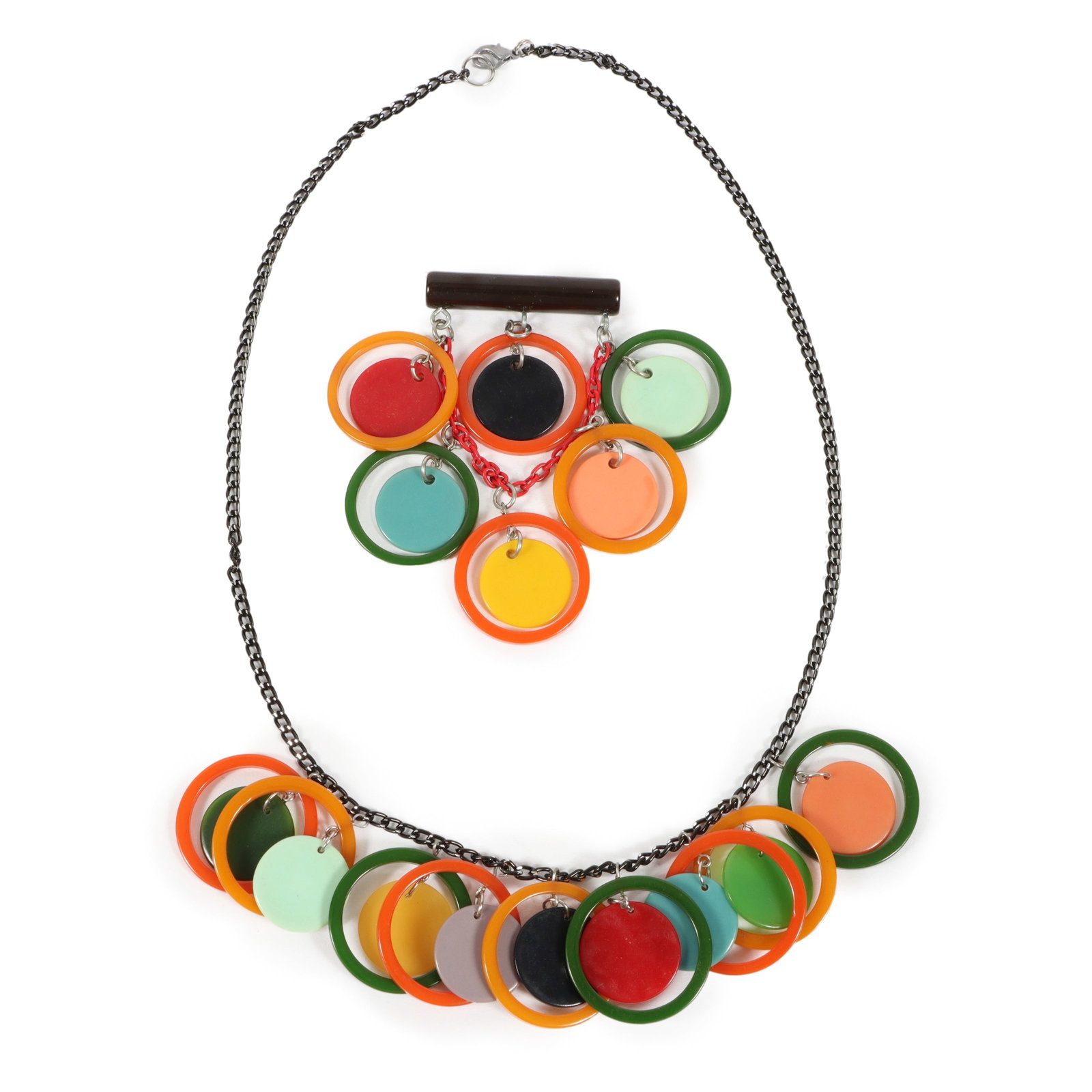 Artisan Bakelite and celluloid layered circles necklace, with artisan Bakelite layered circles: Artisan Bakelite and celluloid layered circles necklace, with artisan Bakelite layered circles brooch. Brooch is missing pin back. 23 1/4"L x 1 1/2"W (Necklace)