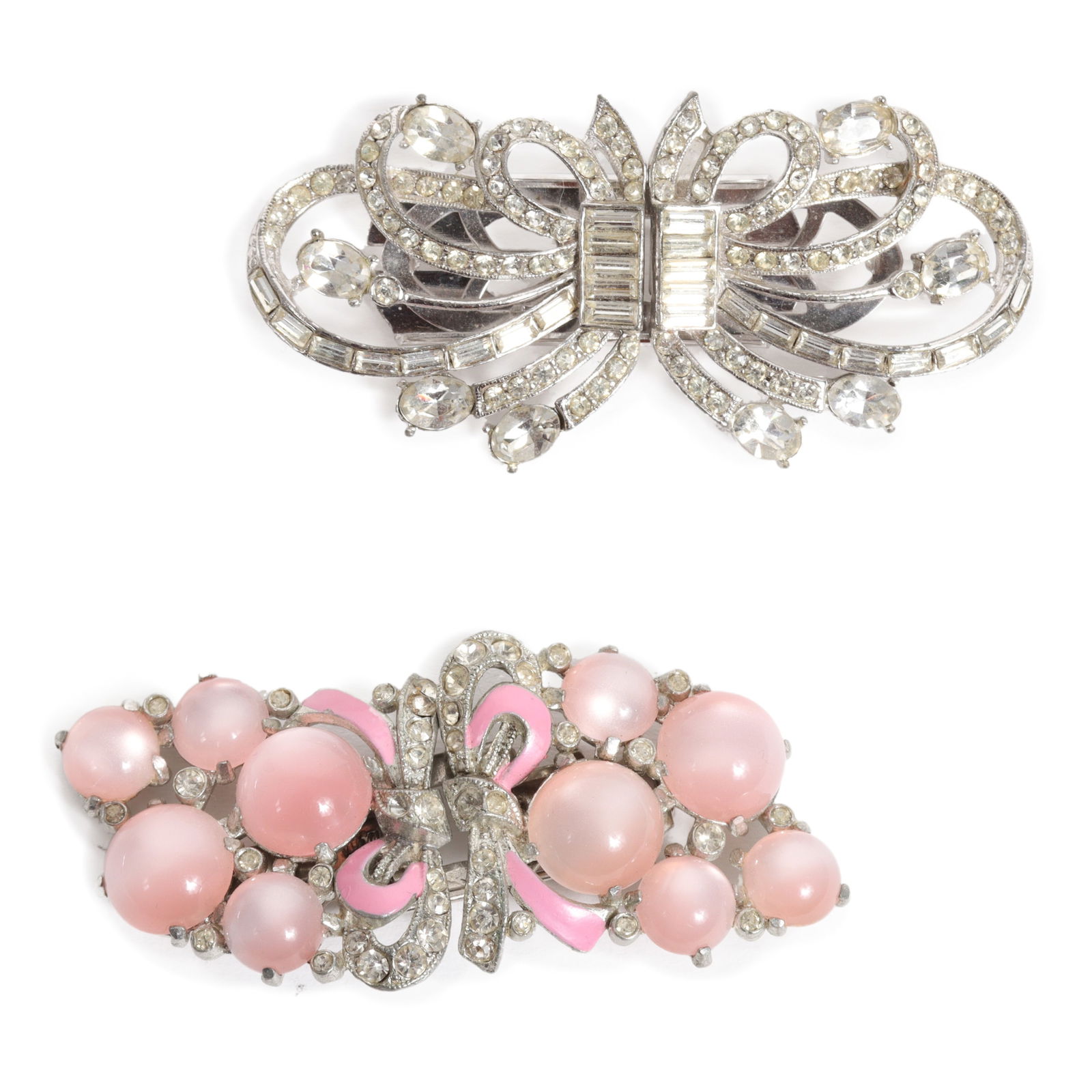 Pink Coro Duette dress clip brooch with clear rhinestone dress clip duette.: Pink Coro Duette dress clip brooch with clear rhinestone dress clip duette. Provenance: From the collection of Cheryl Killmer. 1 3/8"H x 3"W (Pink duette)