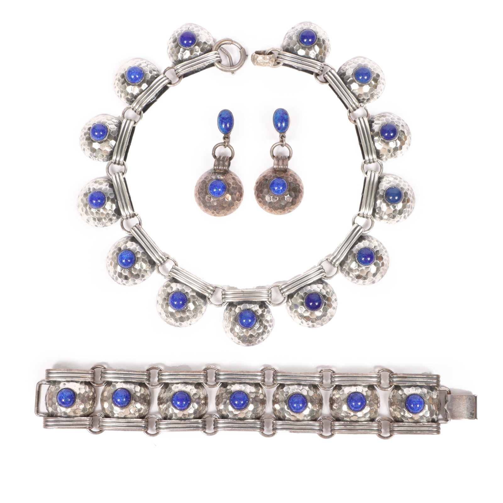 Napier modernist Lapis Lazuli blue art glass parure; collar necklace, bracelet, and earrings with: Napier modernist Lapis Lazuli blue art glass parure; collar necklace, bracelet, and earrings with domed hammered texture. Provenance: From the collection of Cheryl Killmer. 15 1/2"L x 1 1/4"W (necklac