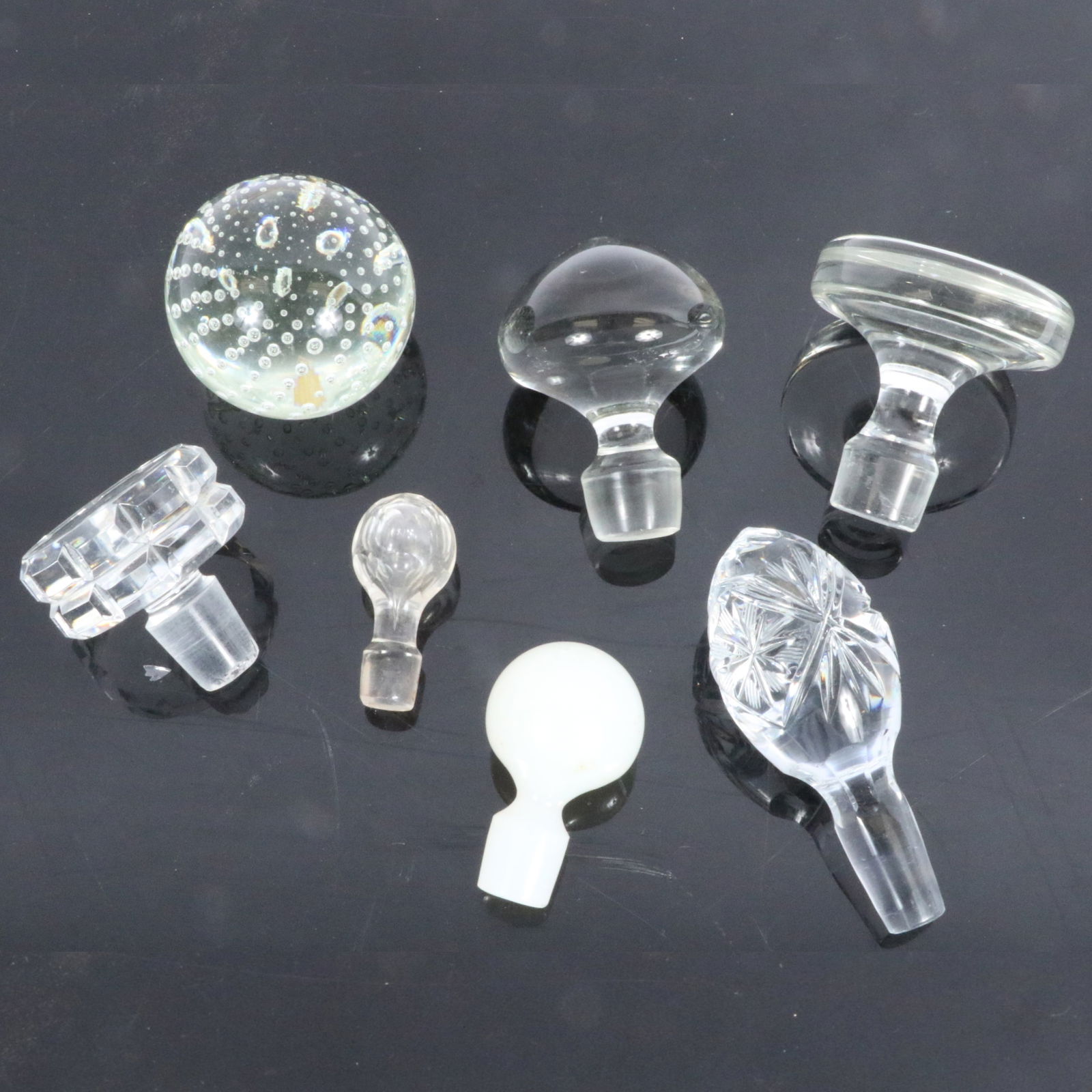 Collection of 6 glass and cut crystal stoppers and a paper weight 2 3/4"H x 3"Diam.(paper weight): Collection of 6 glass and cut crystal stoppers and a paper weight 2 3/4"H x 3"Diam.(paper weight)