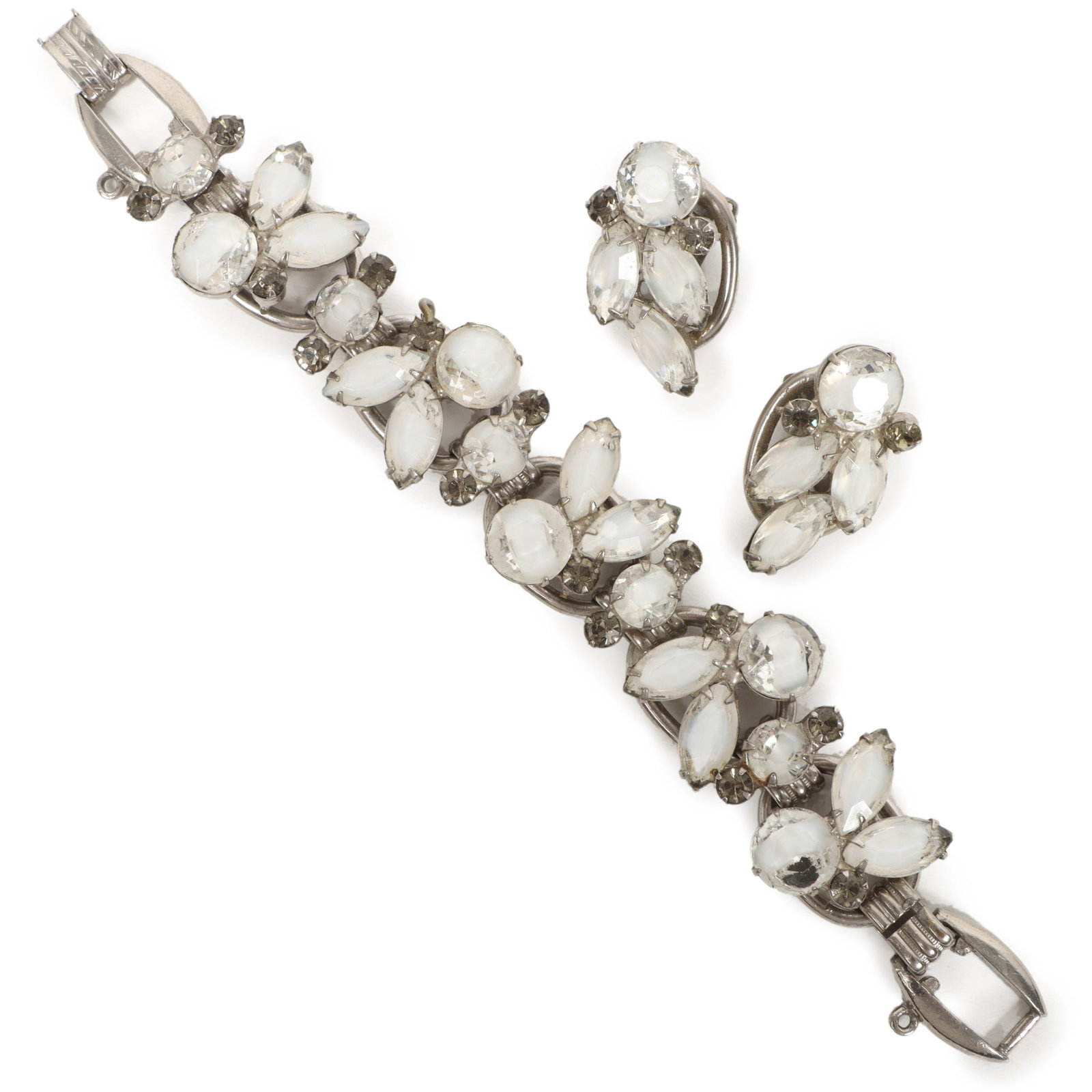 DeLizza & Elster Juliana bracelet and matching earrings; clear and white art glass stones with grey: DeLizza & Elster Juliana bracelet and matching earrings; clear and white art glass stones with grey rhinestones. Provenance: From the collection of Cheryl Killmer. 7 1/8"L x 1"W (bracelet)