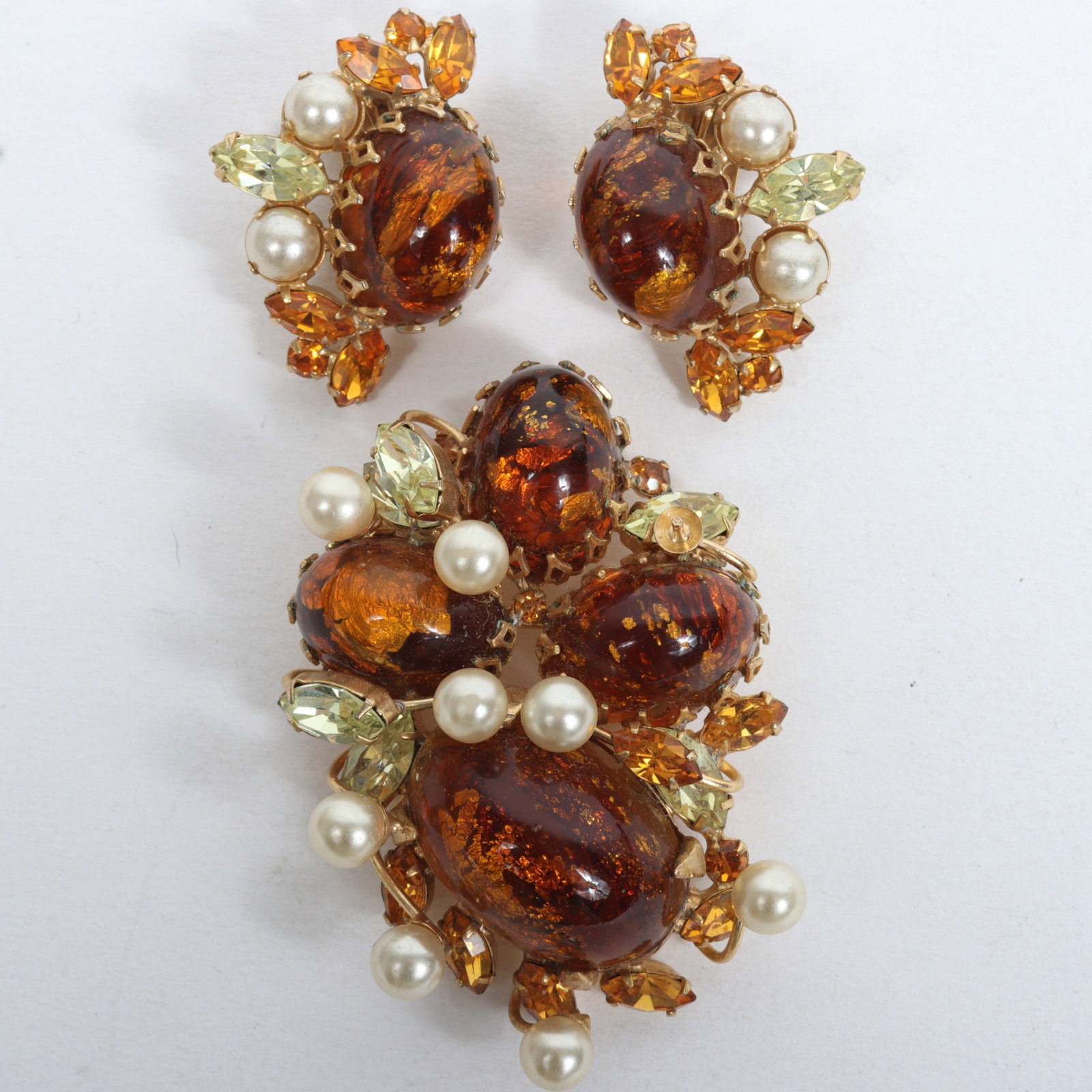 Unsigned Schreiner amber foiled art glass and faux pearl set; jeweled brooch and matching earrings.: Unsigned Schreiner amber foiled art glass and faux pearl set; jeweled brooch and matching earrings. Provenance: From the collection of Cheryl Killmer. One missing pearl. 2 1/4" H x 1 5/8" W