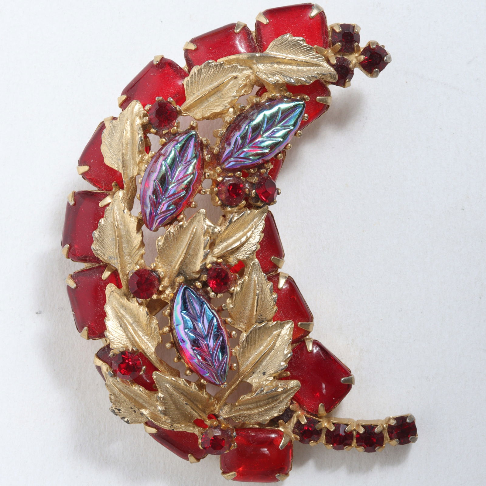 Juliana? jeweled leaf brooch with iridescent molded glass leaf jewels, cherry red glass cabochons,: Juliana? jeweled leaf brooch with iridescent molded glass leaf jewels, cherry red glass cabochons, and ruby red rhinestones. Provenance: From the collection of Cheryl Killmer. 3" H x 2 1/4" W
