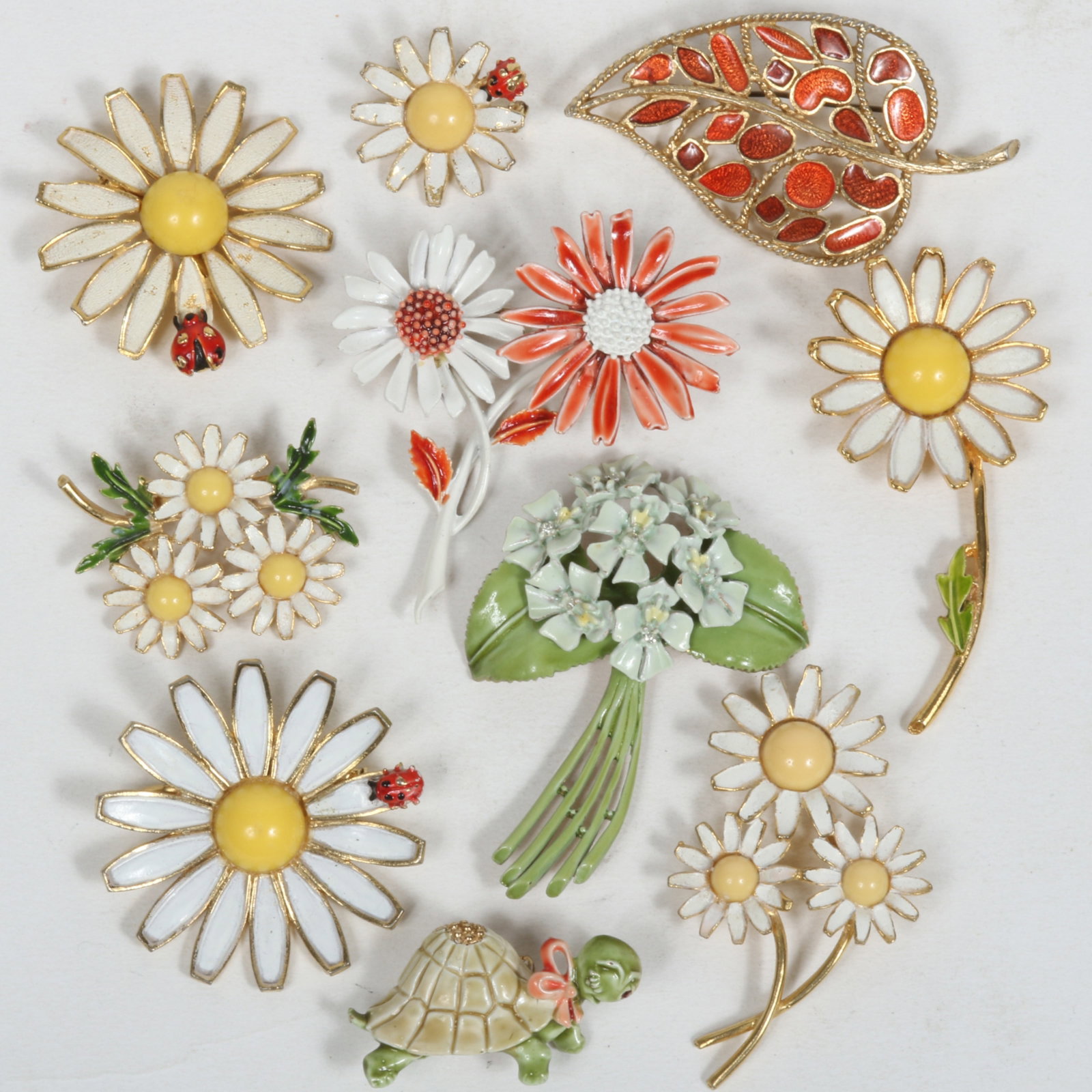 Vintage jewelry group of enamel flowers including Weiss, Art, Florenza, BSK, and HAR turtle brooch.: Vintage jewelry group of enamel flowers including Weiss, Art, Florenza, BSK, and HAR turtle brooch. Provenance: From the collection of Cheryl Killmer. 1" H x 1 3/4" W (HAR Turtle Brooch).